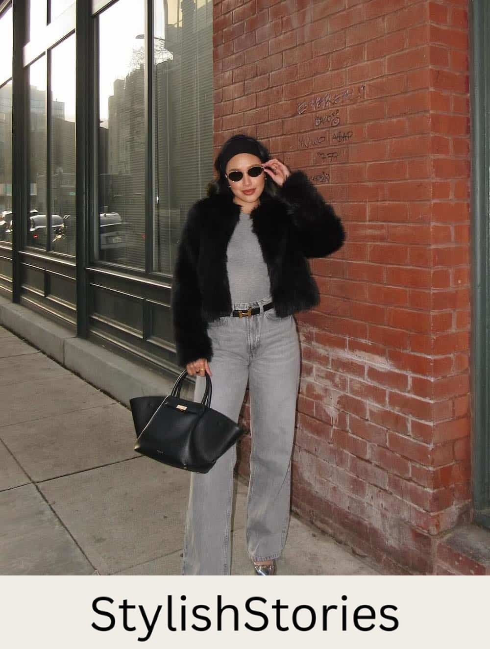 a winter concert outfit featuring grey wide-leg jeans, a grey tank, silver pumps, and a faux fur black coat