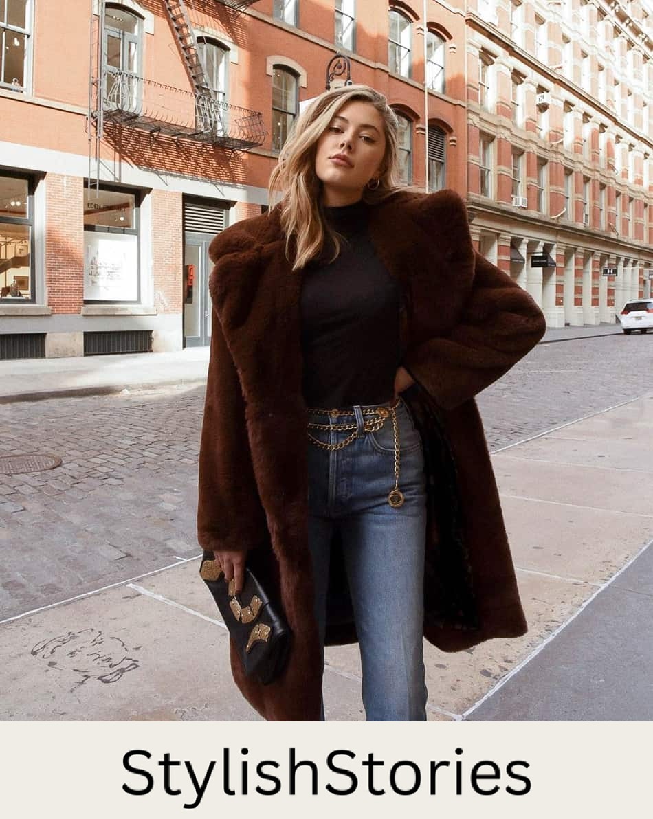 woman wearing a faux fur brown coat with a black turtleneck sweater and jeans