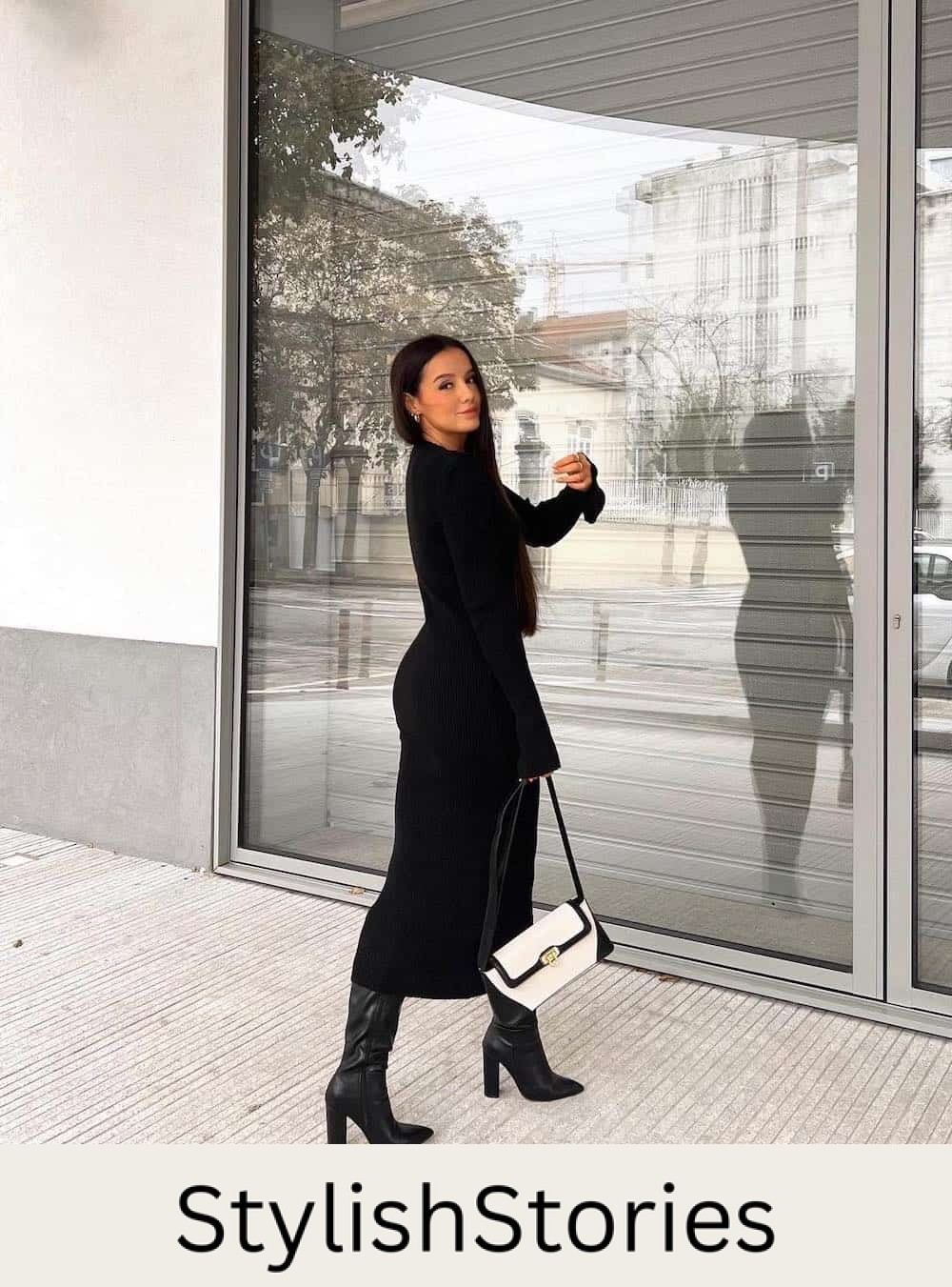 Woman wearing tall black boots with a black midi length sweater dress.