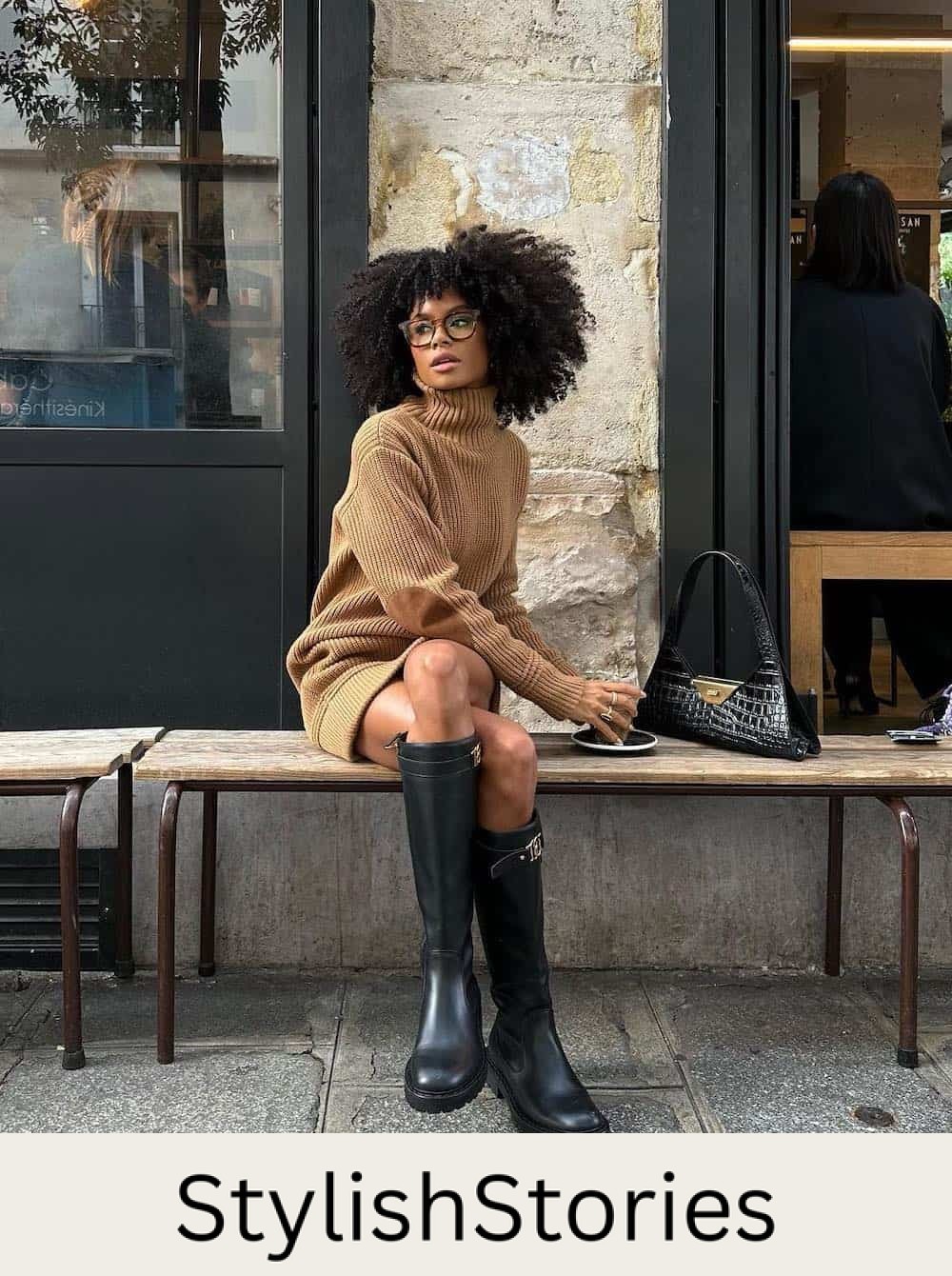 Woman wearing tall black boots with a camel colored sweater dress.