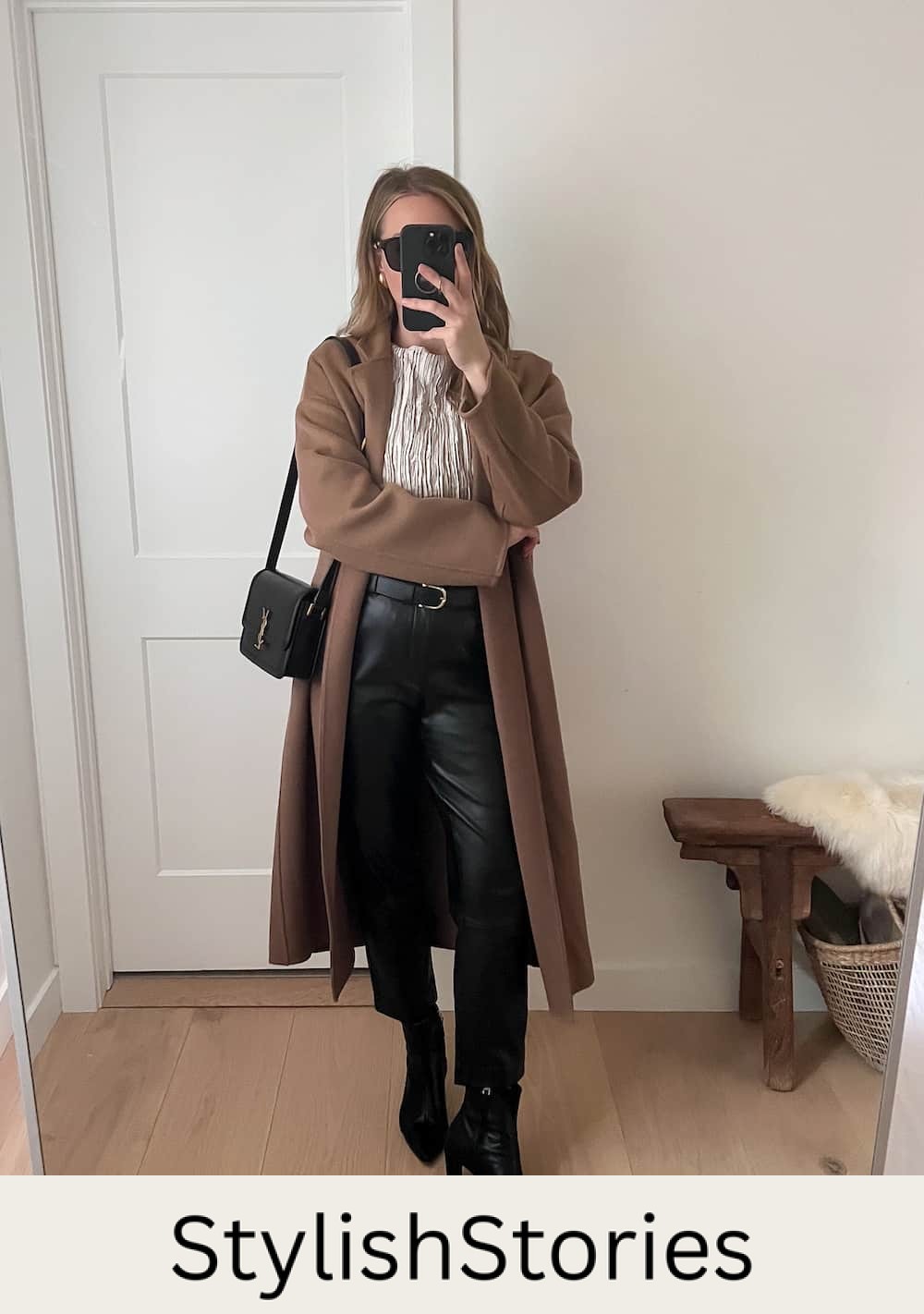 Christal wearing black leather pants with black booties, a silver top and a camel colored coat.