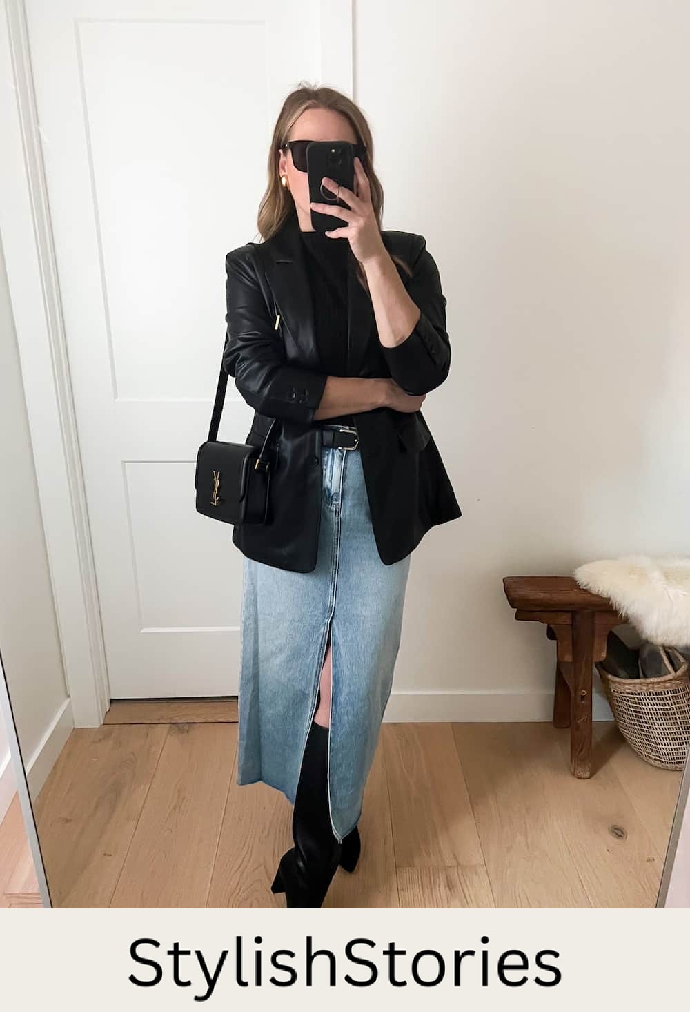 Christal wearing a long denim skirt with tall black boots and a black leather jacket.