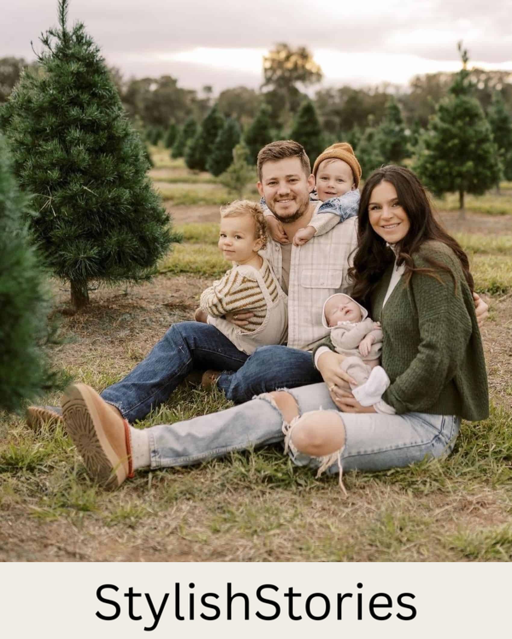 A winter family photo where the the family is dressed casually in jeans, sweaters, and flannels in green, beige, and white tones