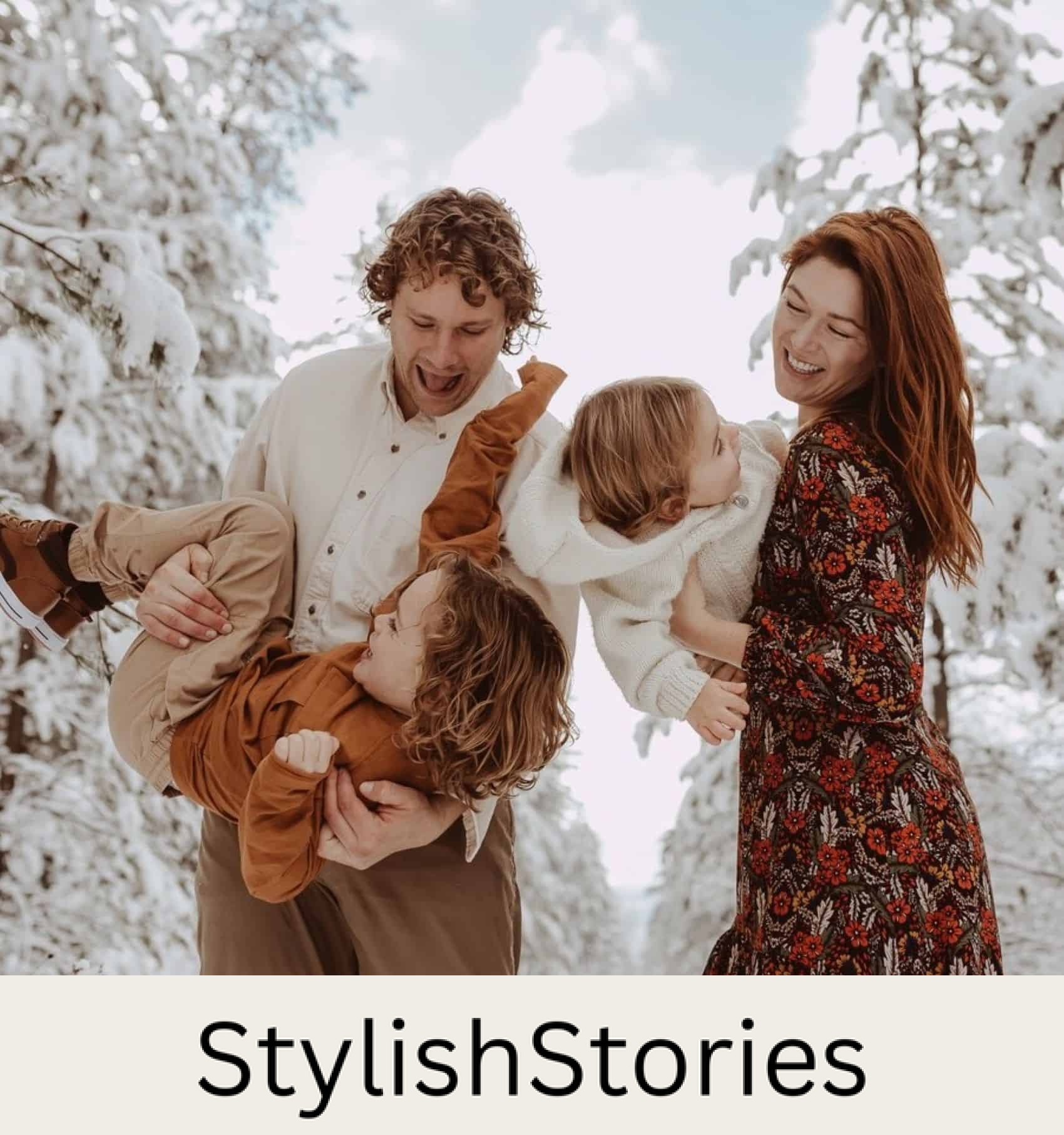 A winter family photo where the mom is wearing a red and brown floral dress, and other family members are wearing orange, tan, and white pieces