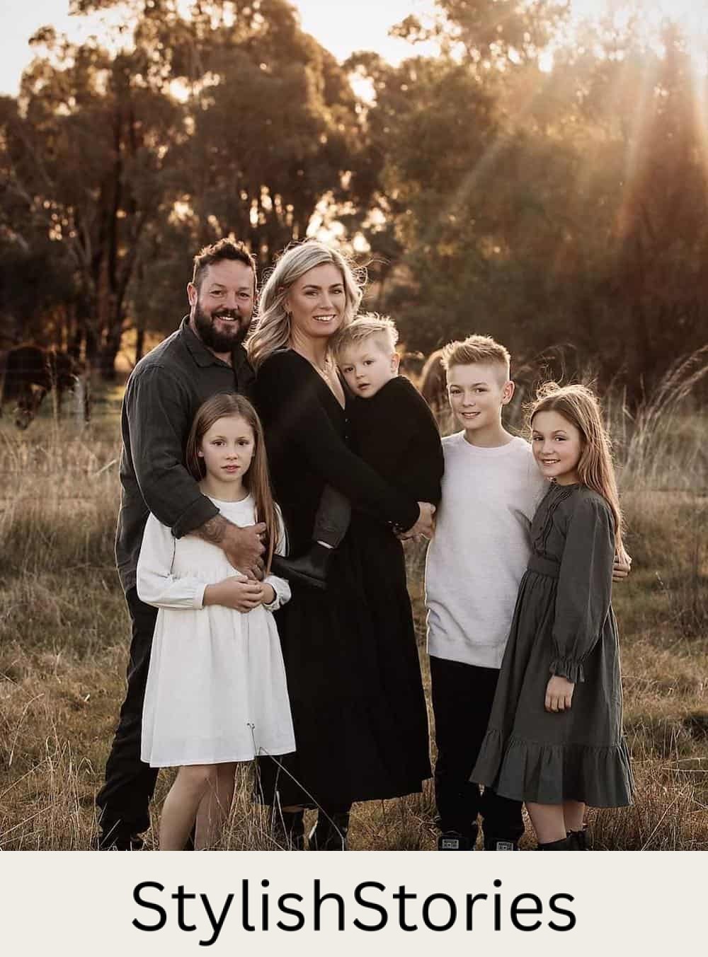a winter family photoshoot with outfits featuring black, white, and grey outfits
