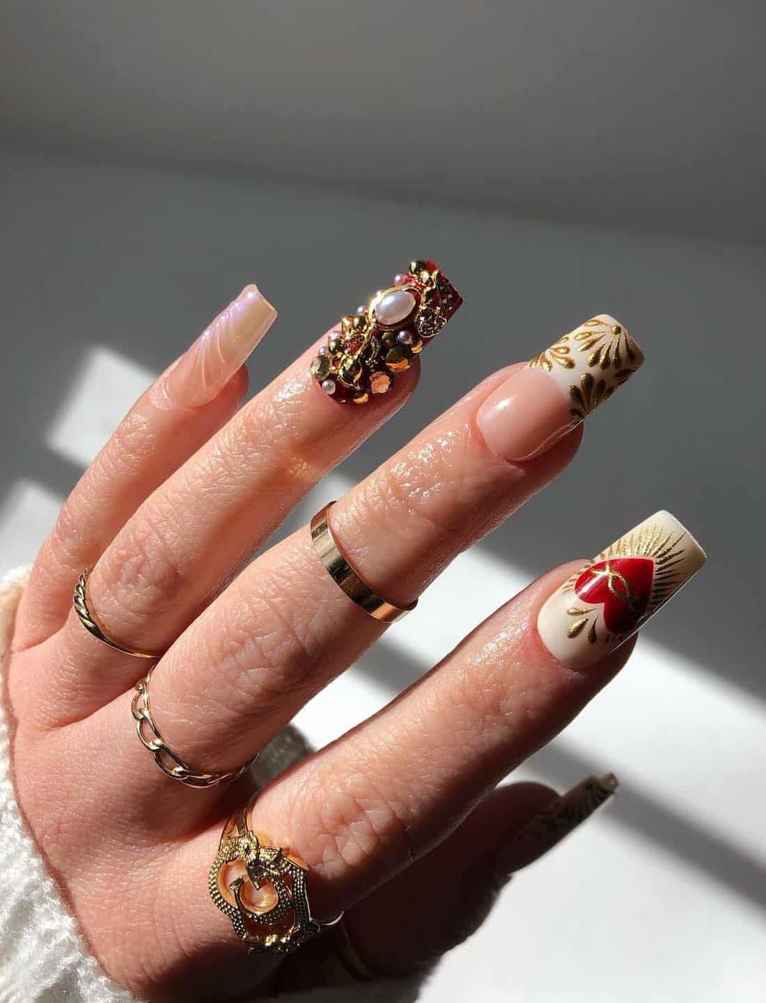 long square nails with castlecore inspired nail art, gems, and gold accents