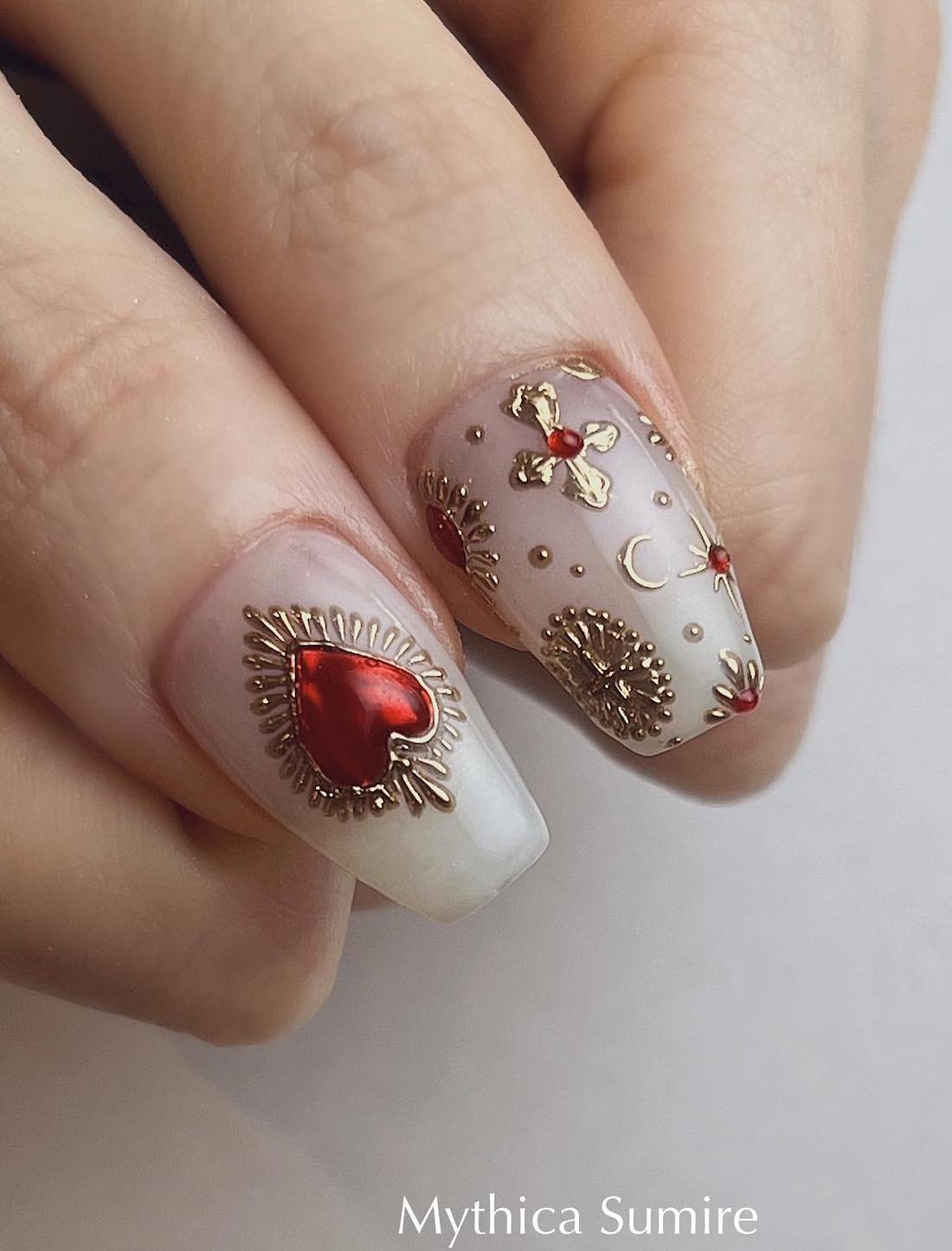 milky white nails with red and gold castlecore art