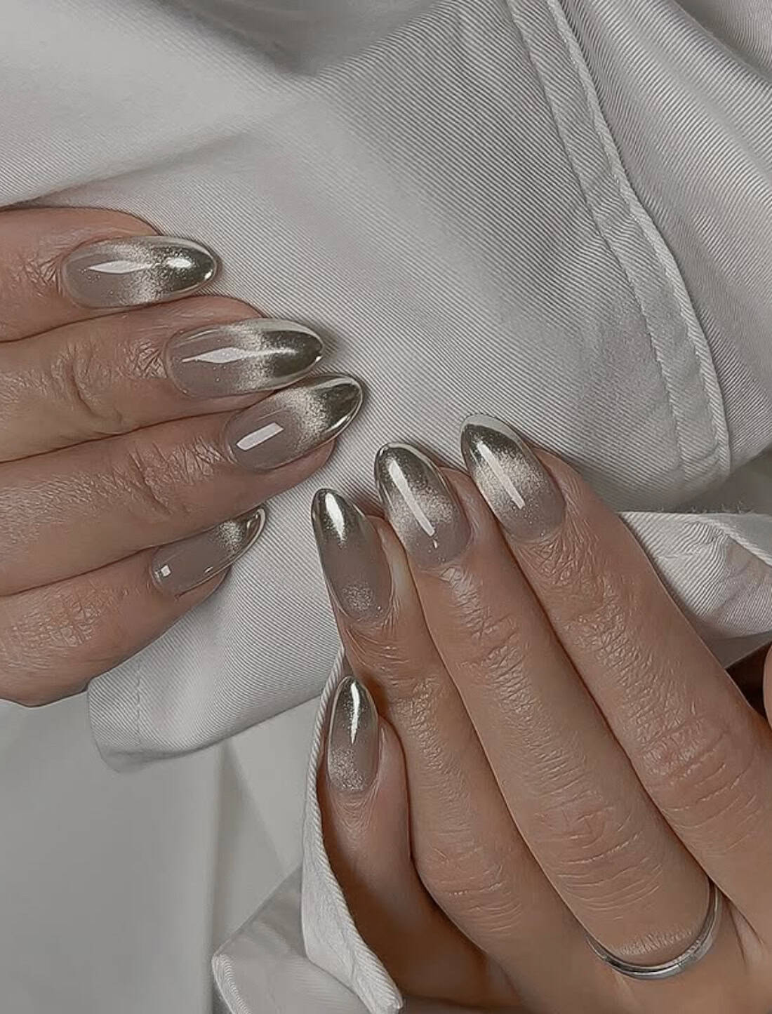 medium almond nails with silver cat eye french tips
