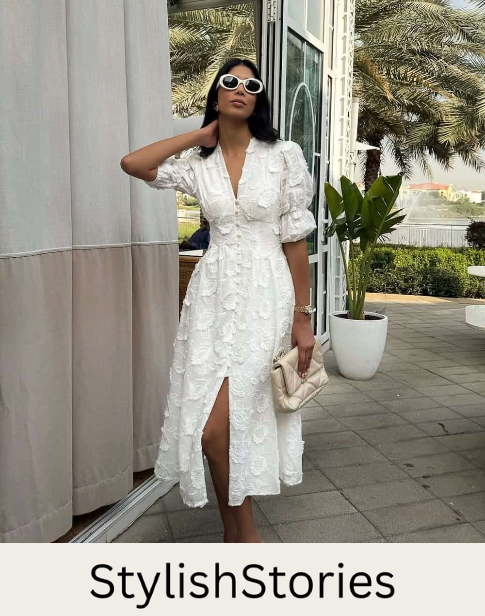 Woman wearing a textured white midi dress with white sandals.