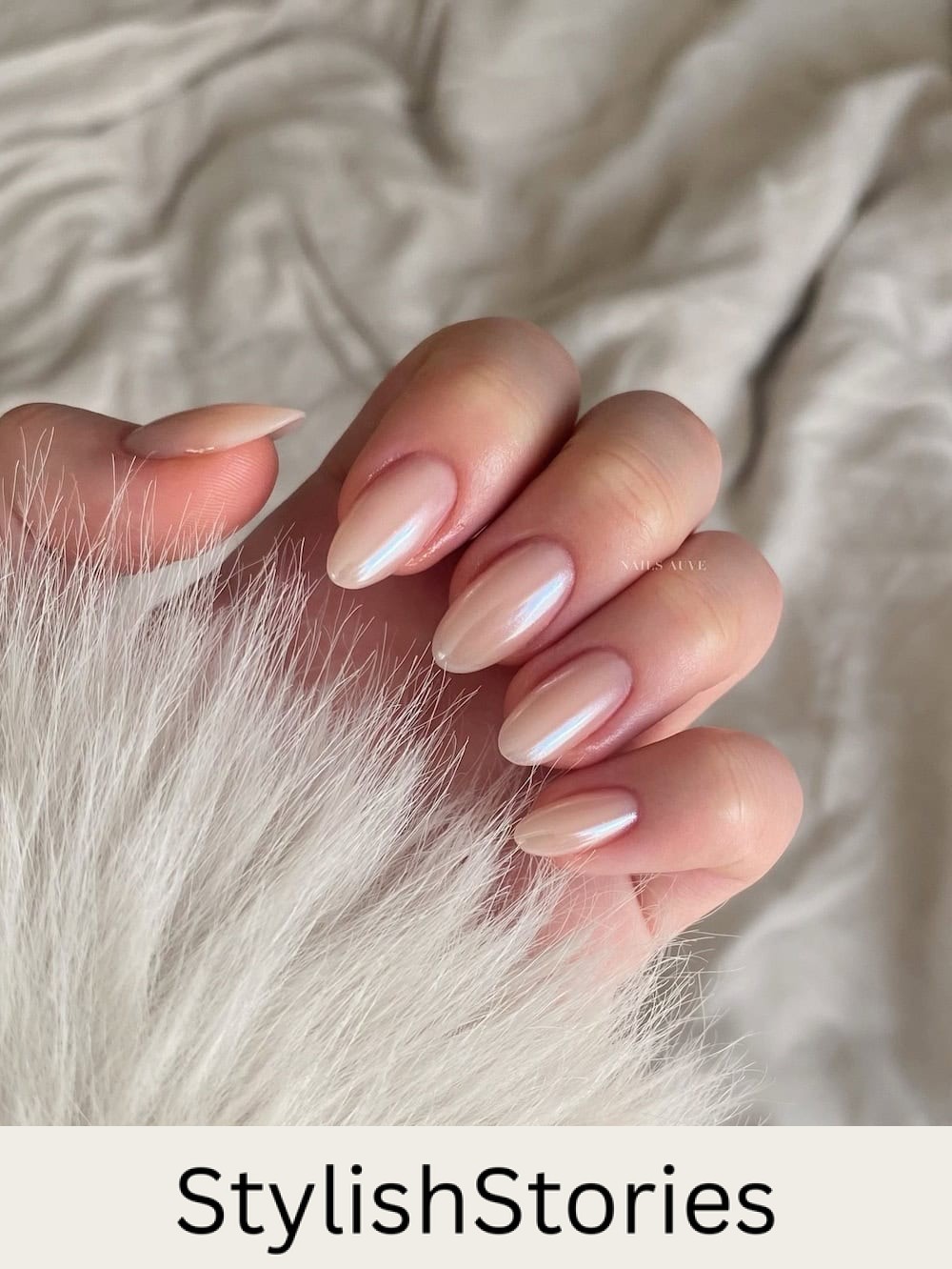short pearly almond nails in a champagne polish