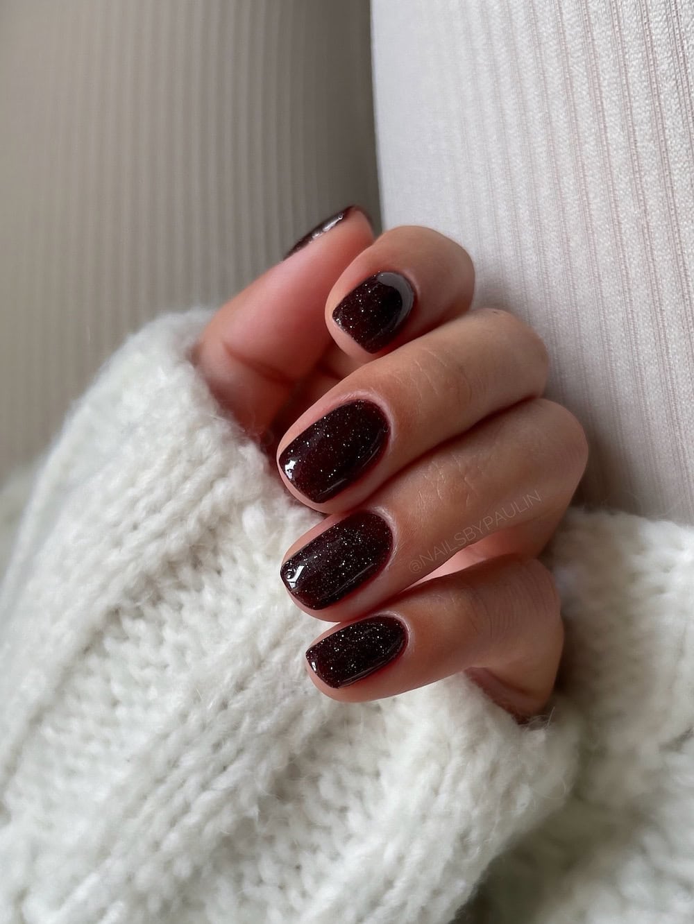 short brown nails with white speckled finish