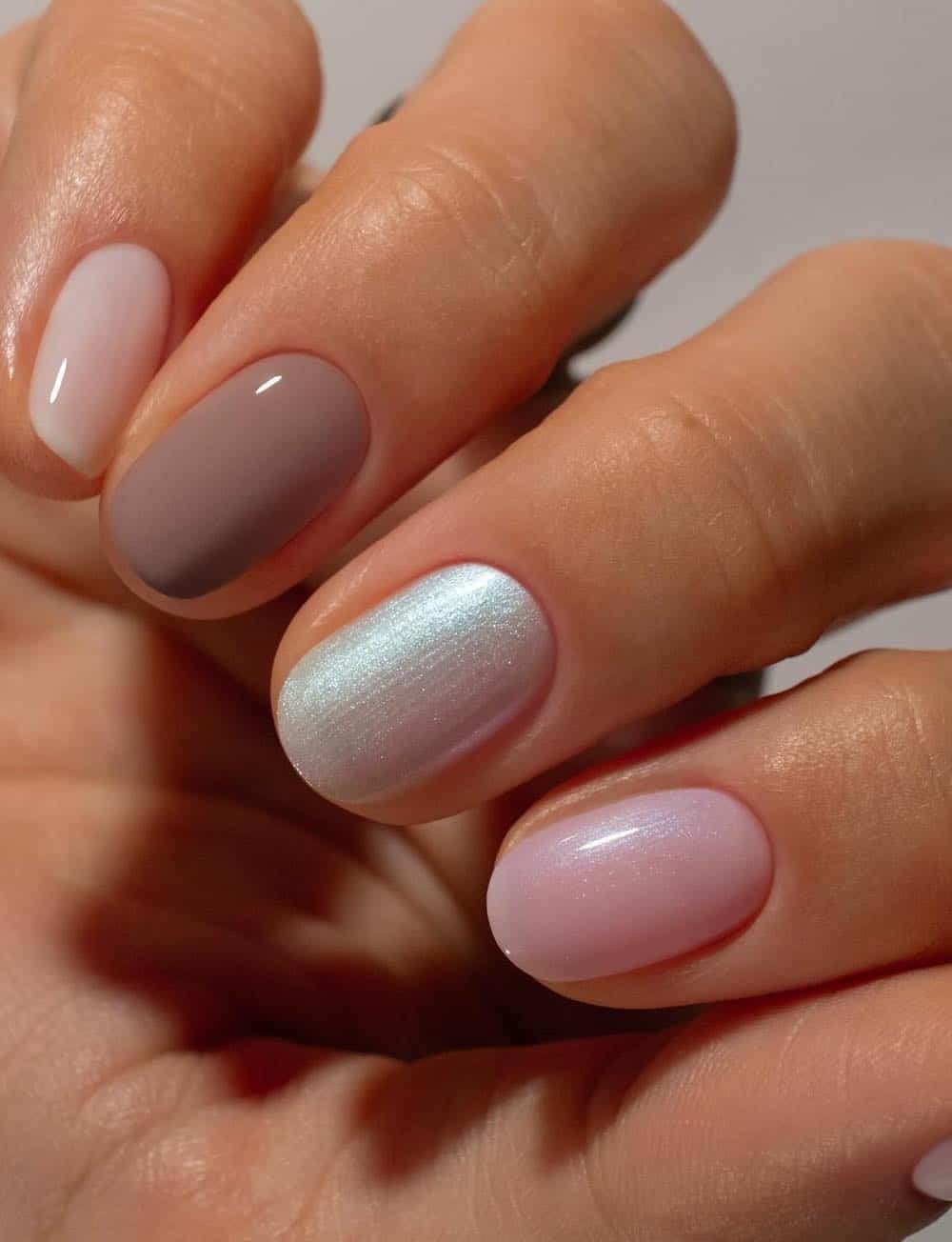 short round nails with brown, milky white, pearly white, and shimmering pink polish