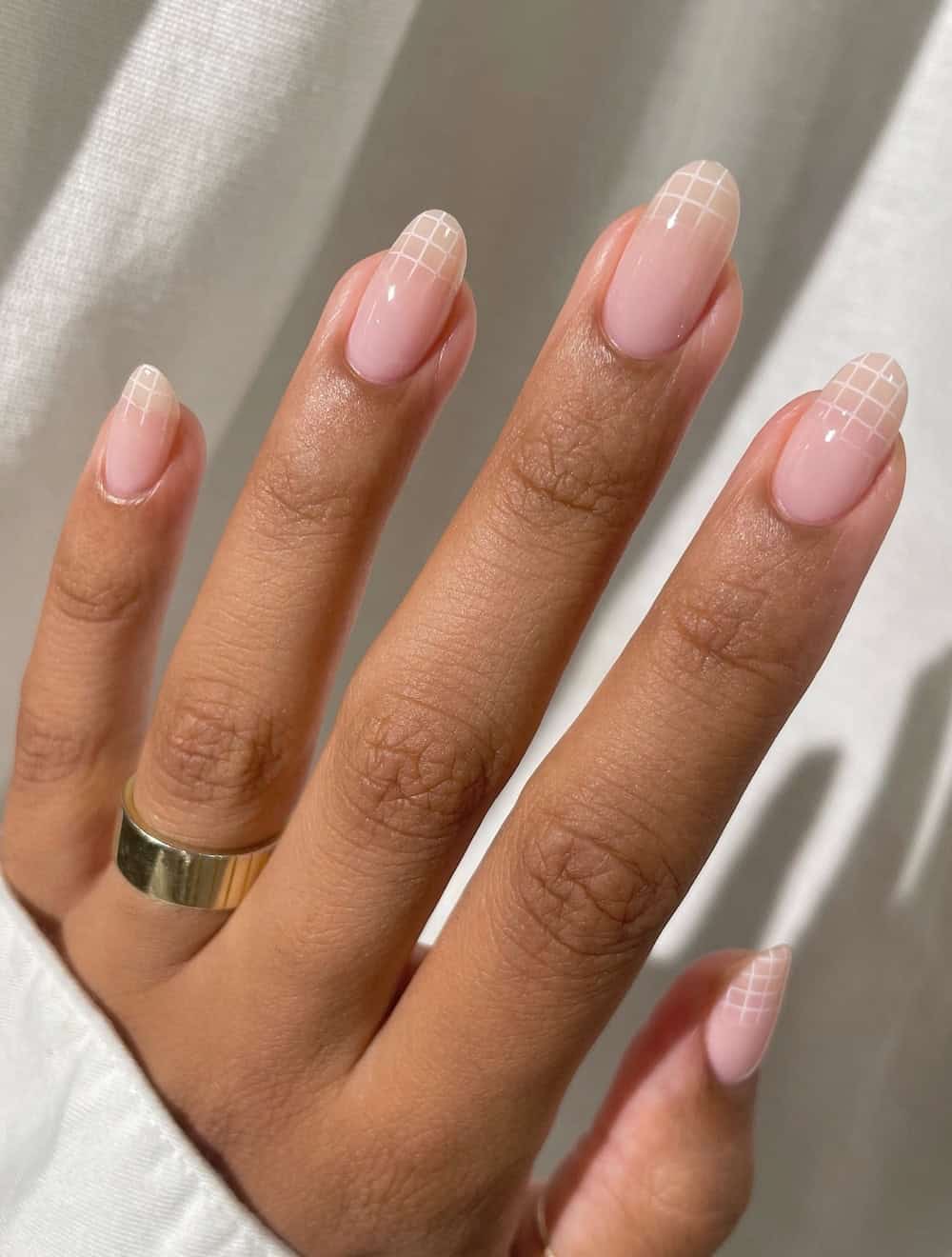 soft pink round nails with white grid line tips