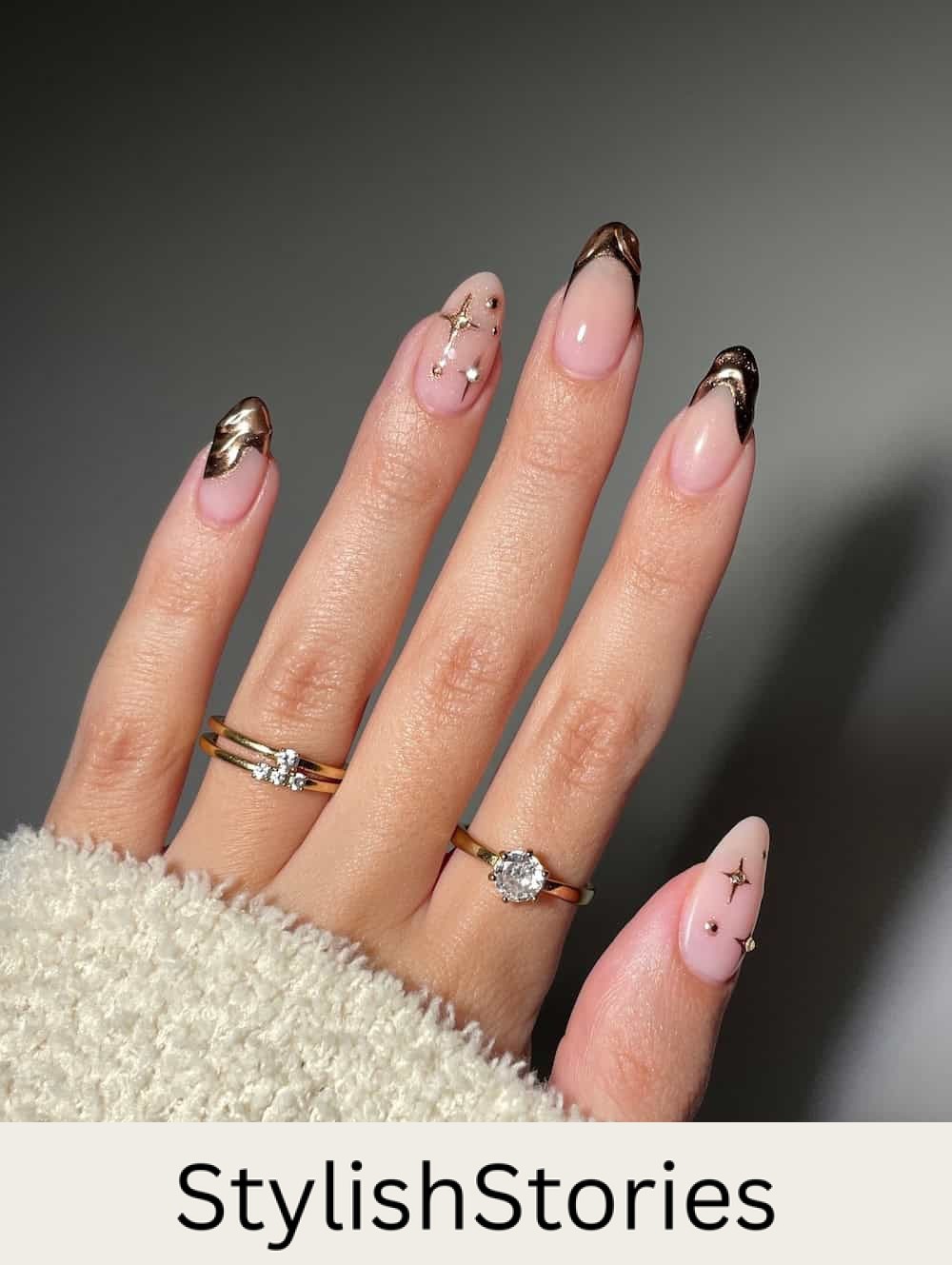 short round nude nails with molten bronze tips and sparkle and gem accents