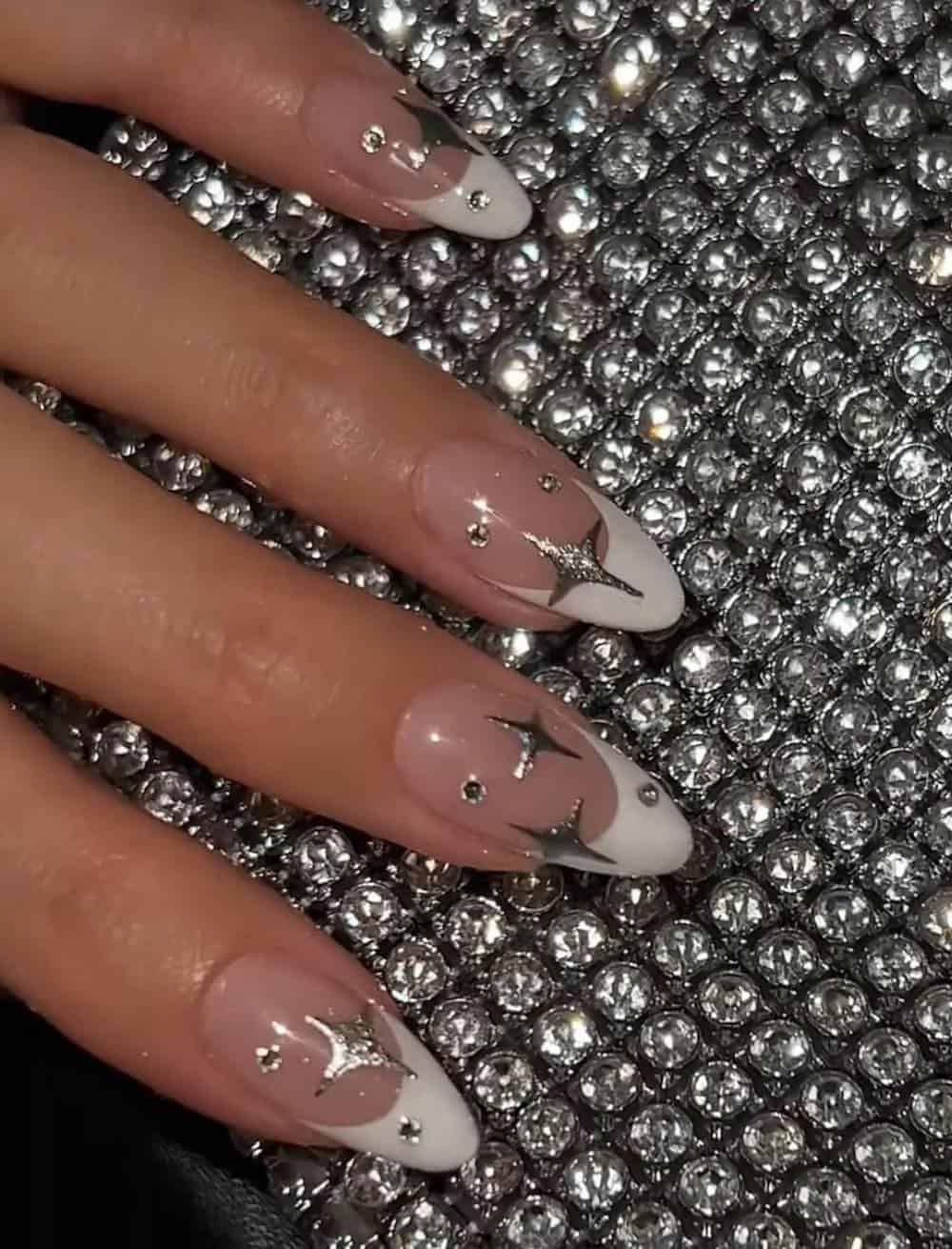 long nude nails with white tips and silver sparkles