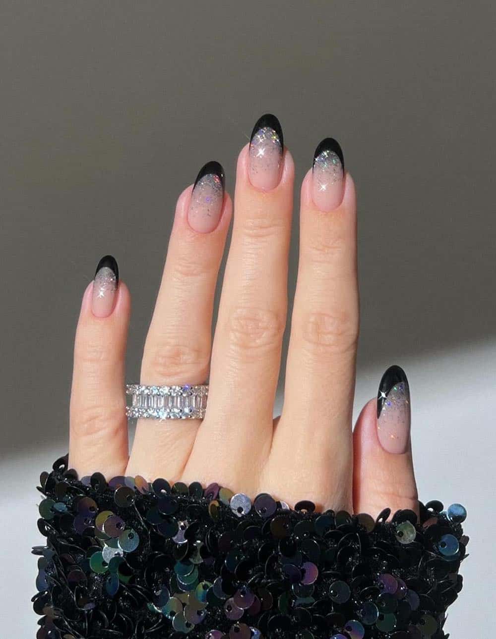 nude round nails with silver glitter ombre and black tips