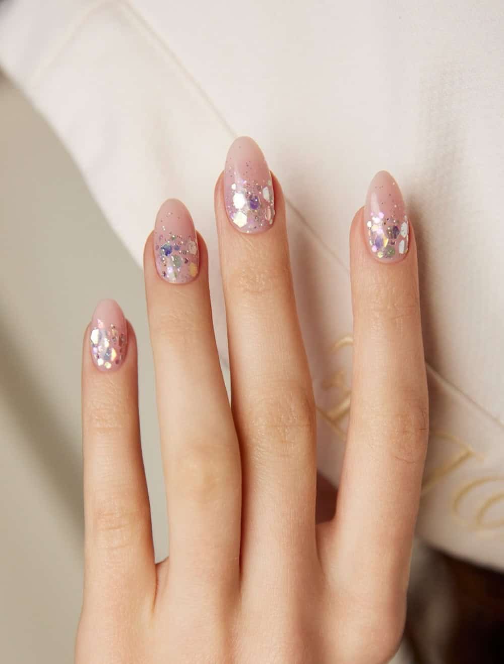 short nude pink nails with chunky silver glitter ombre