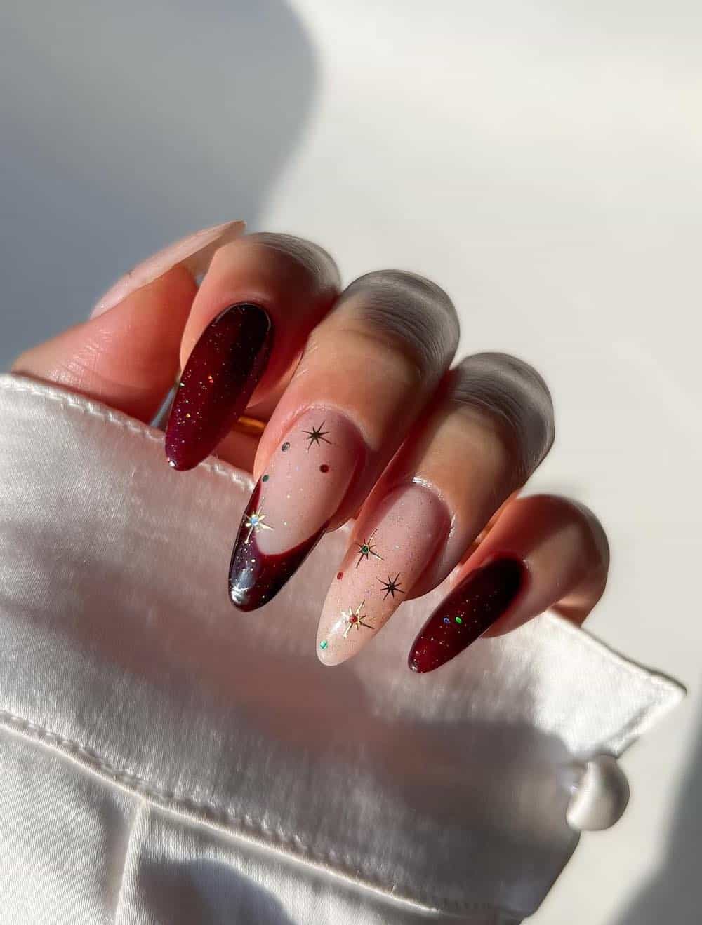 long red and nude nails with gold sparkles