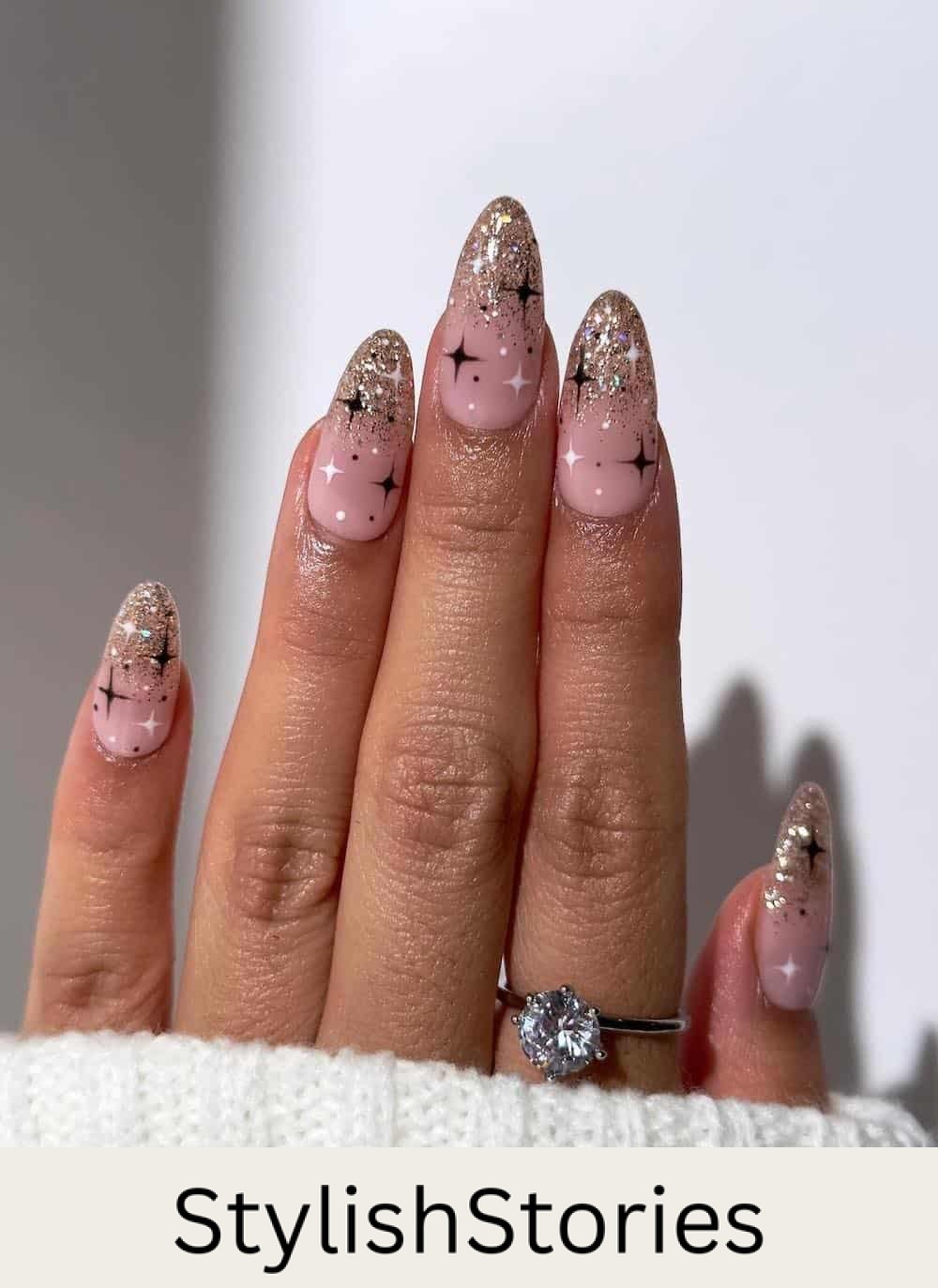 long nude pink nails with gold glitter ombre tips and neutral sparkle art