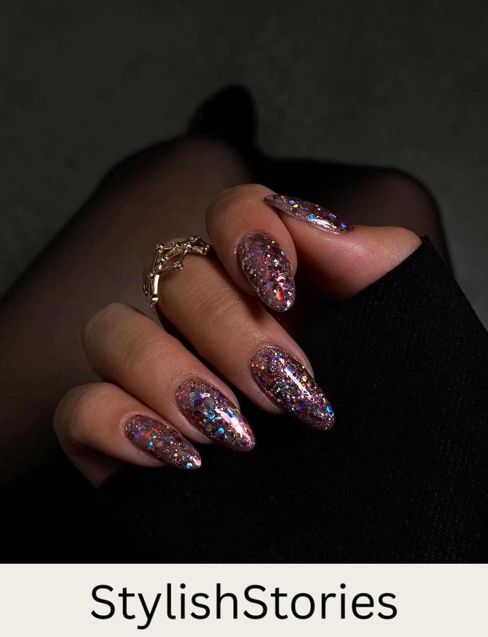 long almond nails with chunky pink, blue, and gold glitter