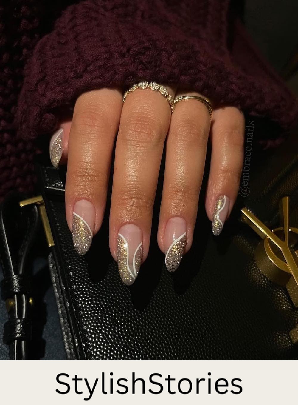 long almond nails with gold glitter waves and white borders