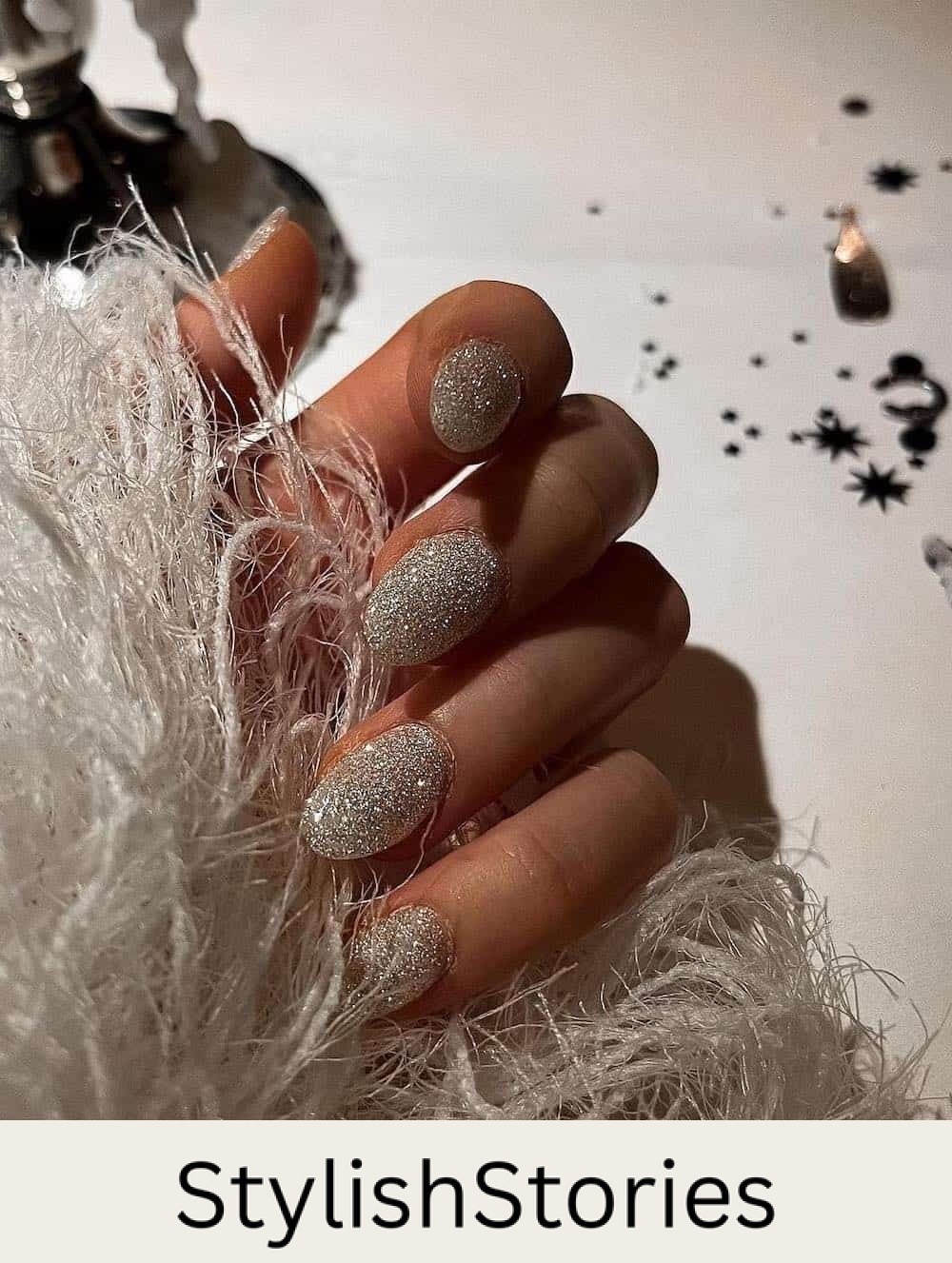 short round nails with thick silver glitter polish