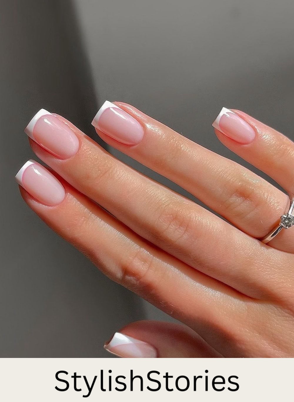 a hand with short square french manicure