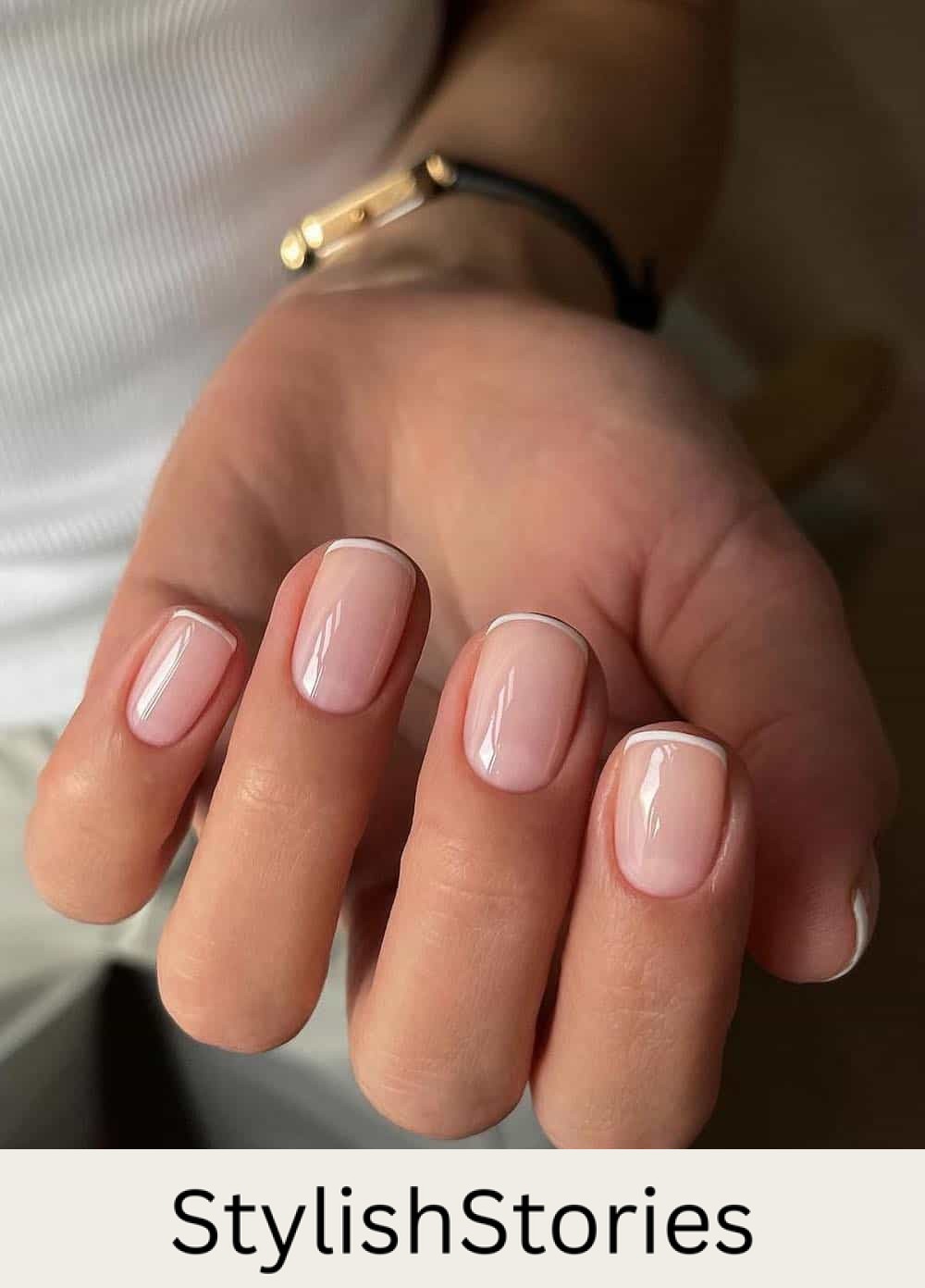 short glossy nude nails with thin white tips