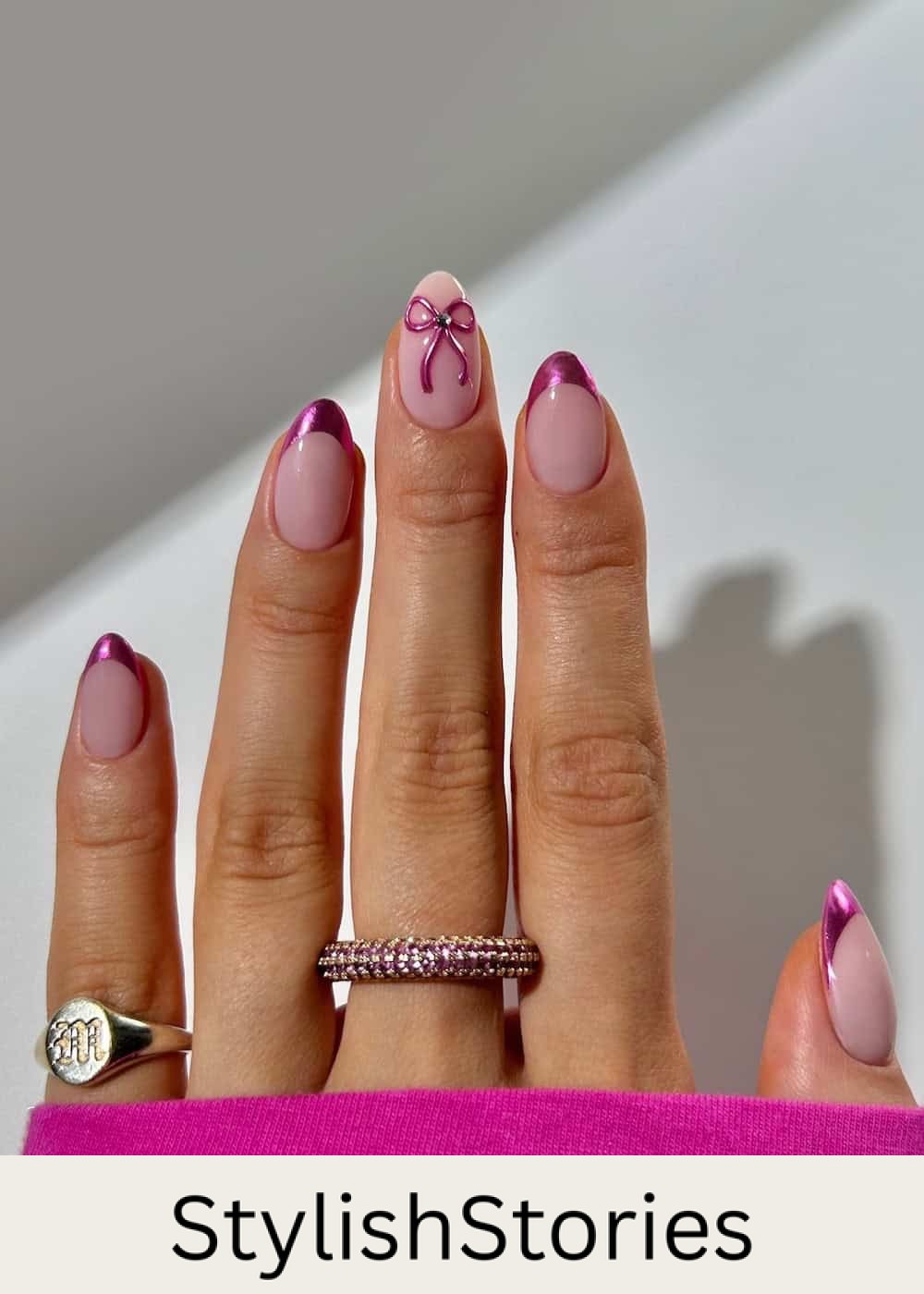 short nude almond nails with chrome pink tips and bows