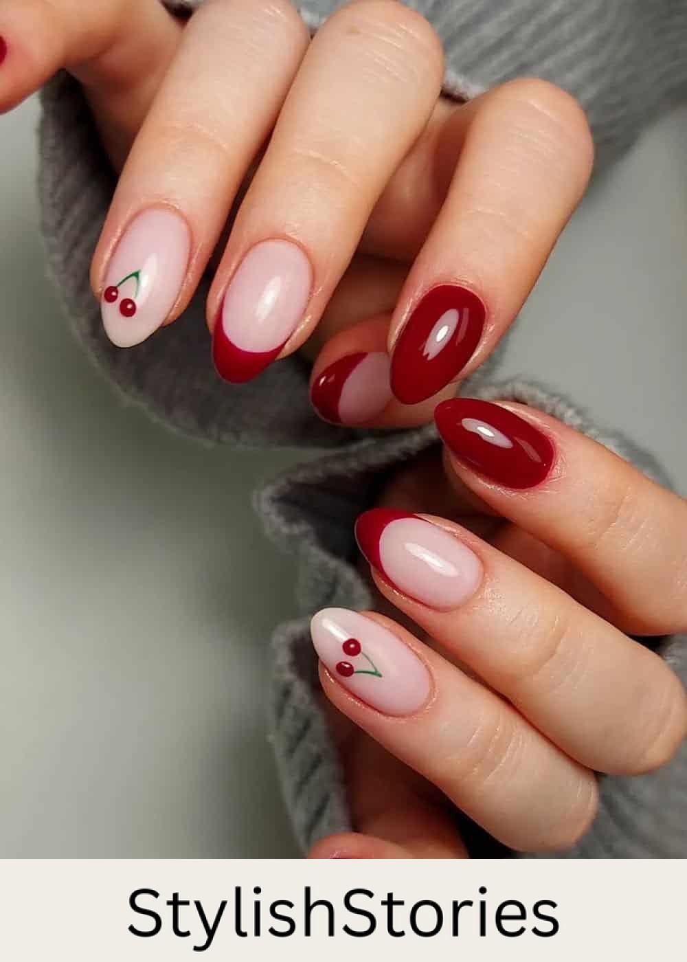 almond nails with red tips, cherry art, and solid nails