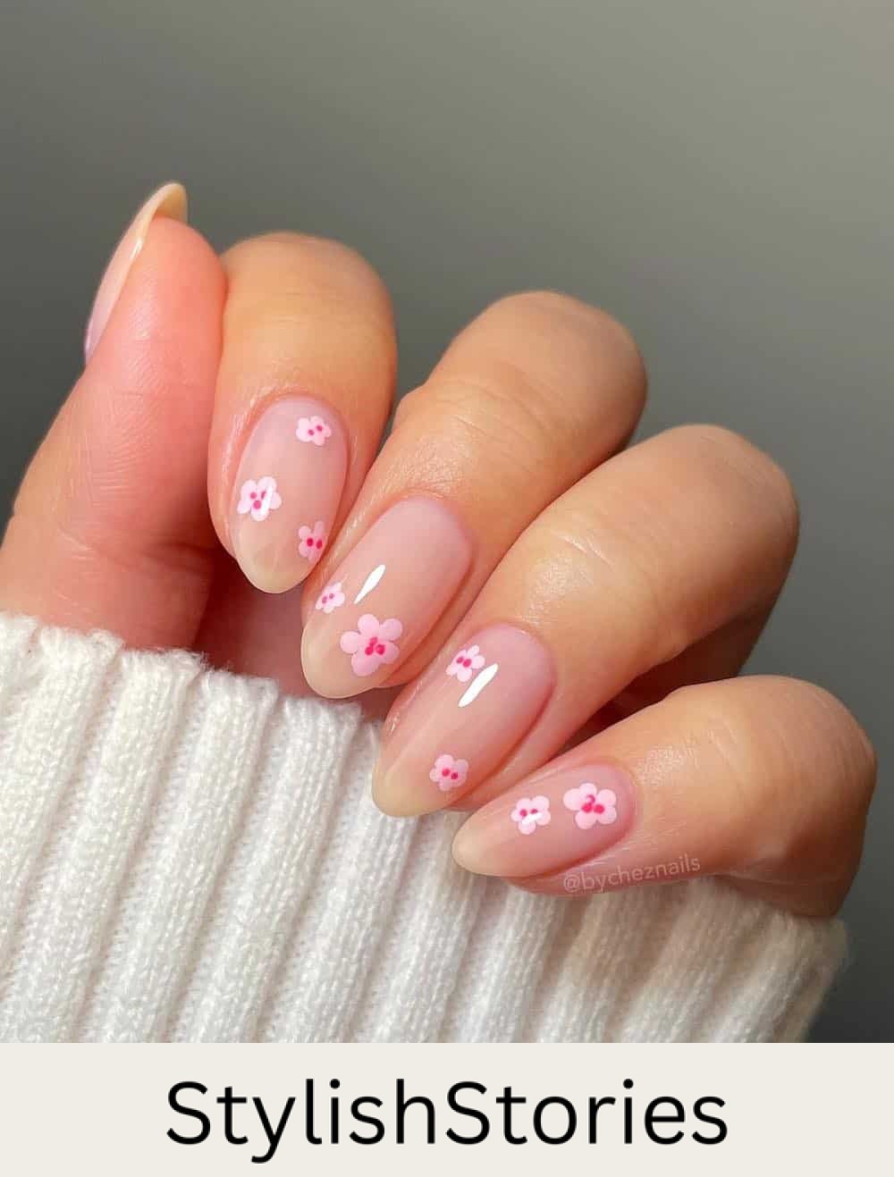 short nude almond nails with pink floral nail art