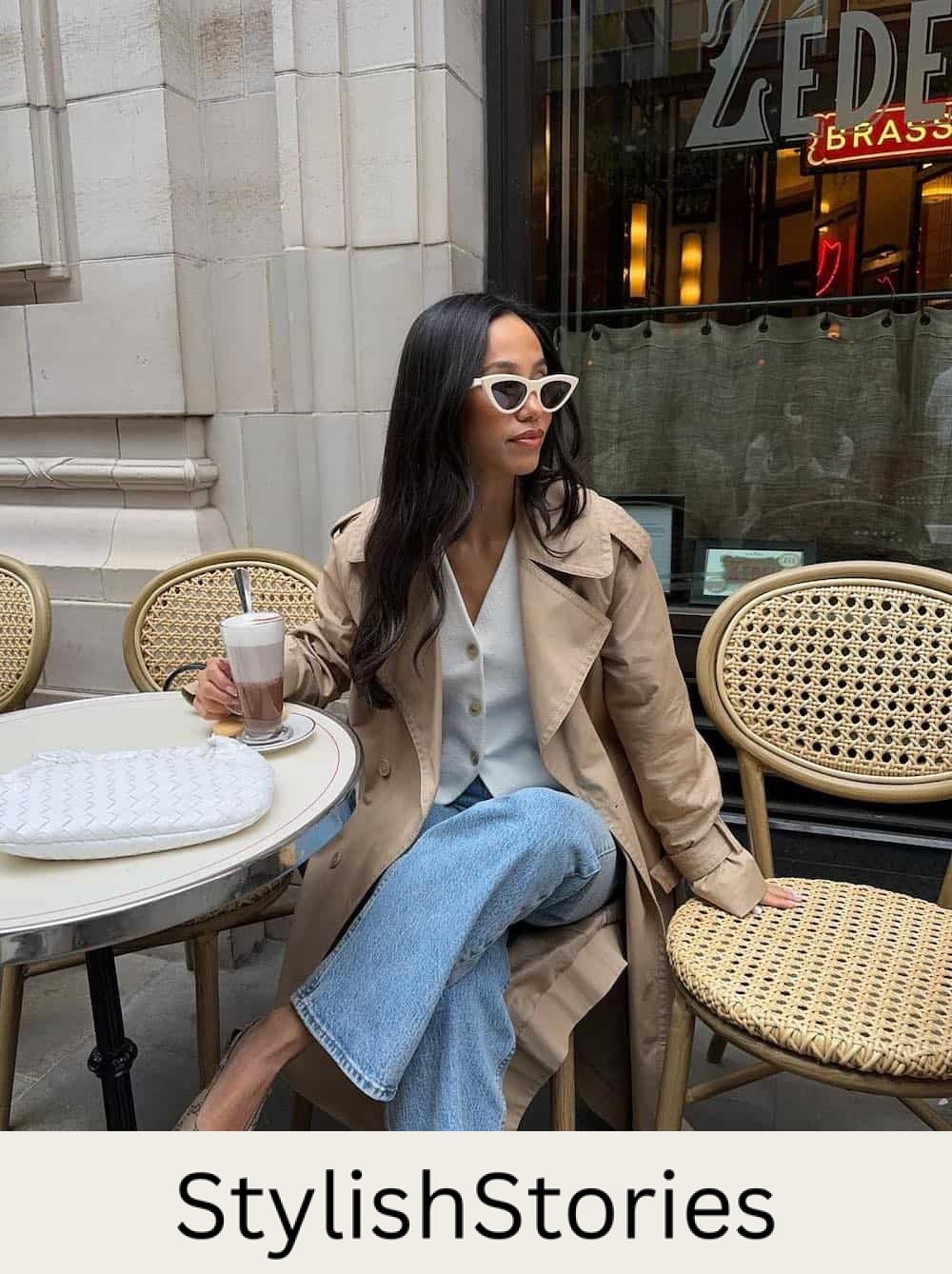 Woman wearing jeans, Gucci flats, a white vest top and a trench coat.