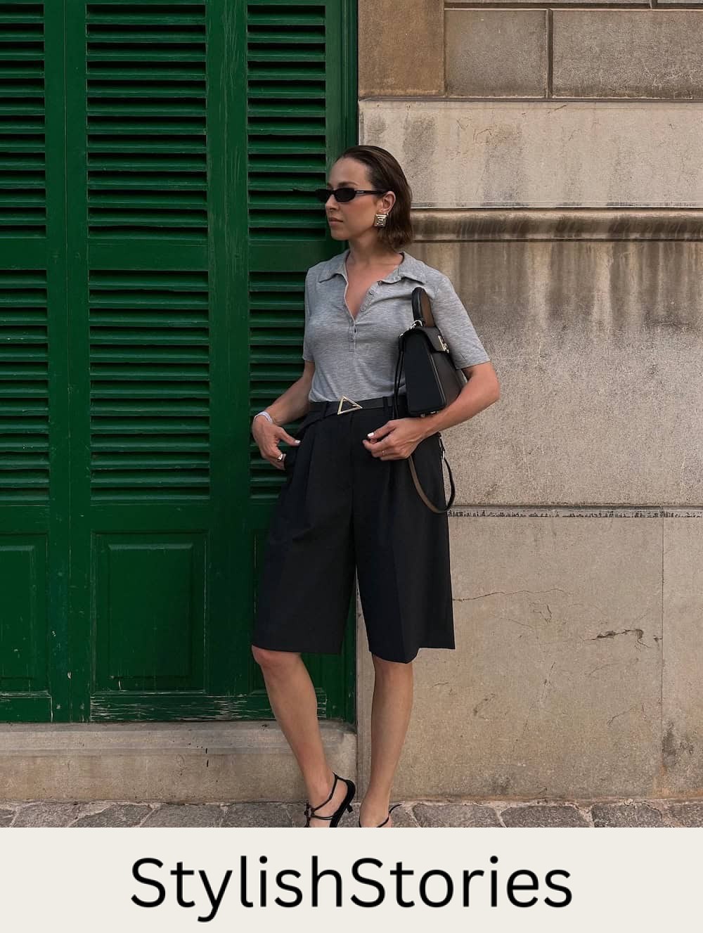Woman wearing black shorts, a gray henly and kitten heel sandals.