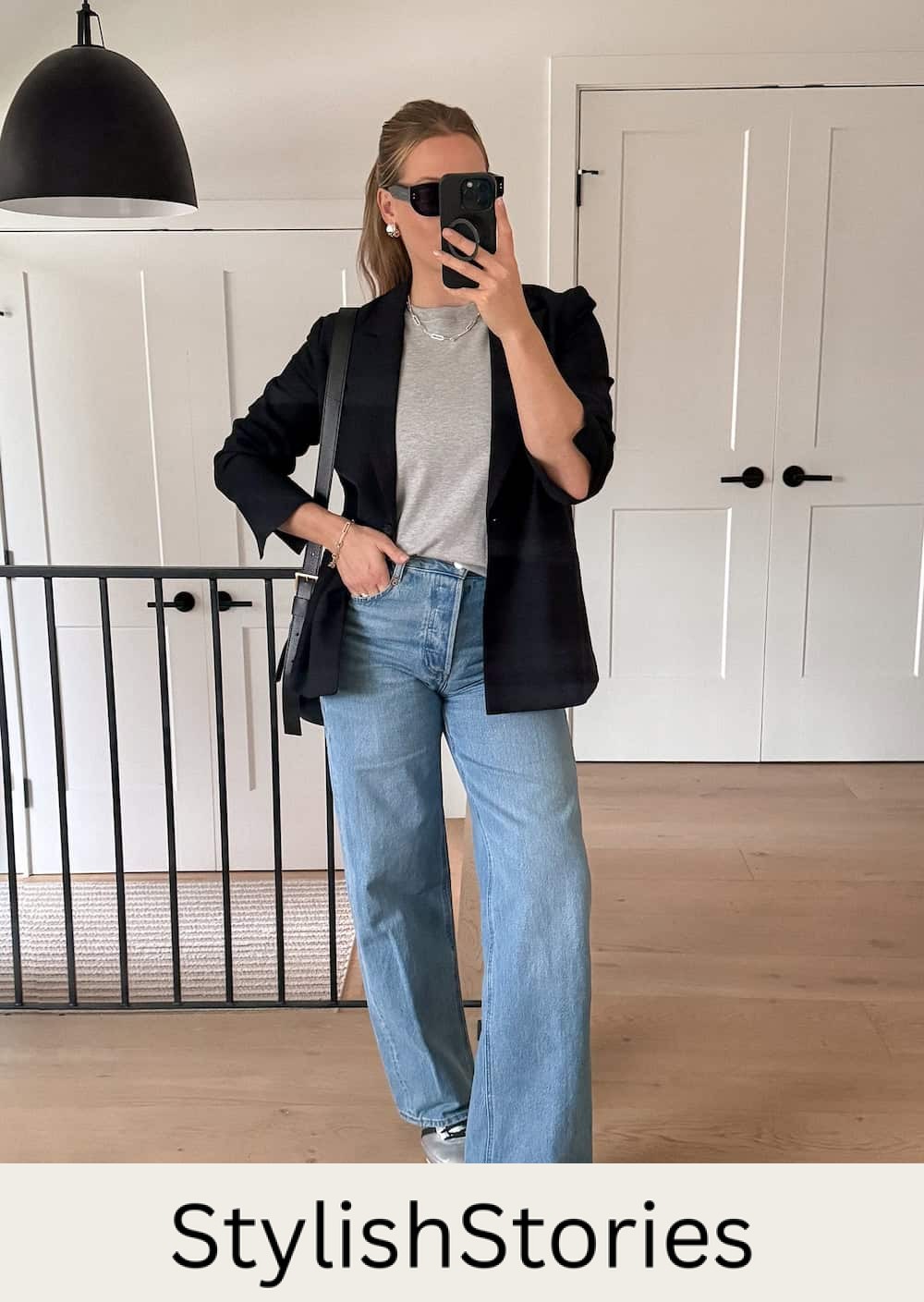 Christal wearing jeans, sneakers, a gray t-shirt and a black cardigan.