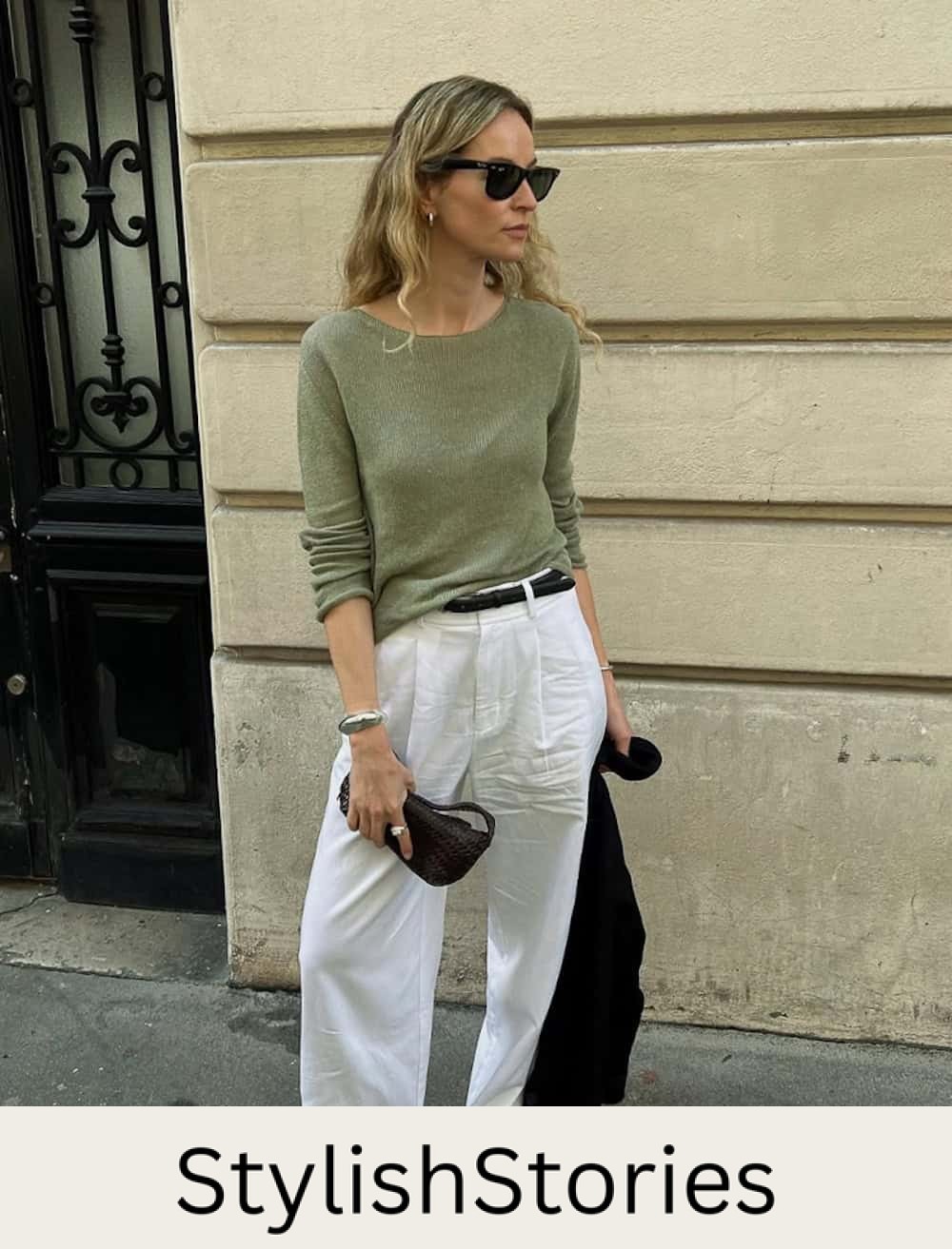 Woman wearing linen pants and a green sweater.