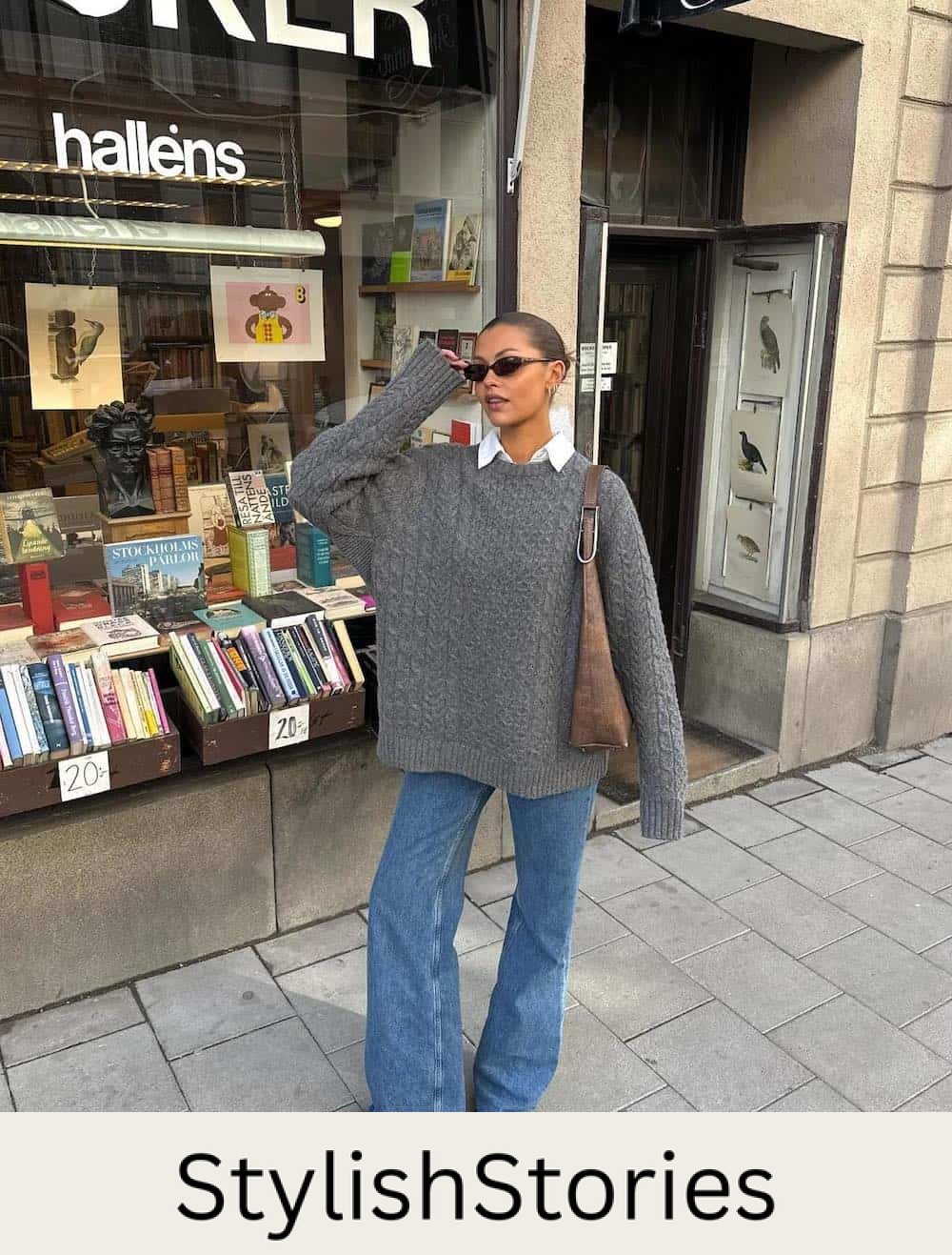 Woman wearing jeans, booties, a button down and an oversized sweater.