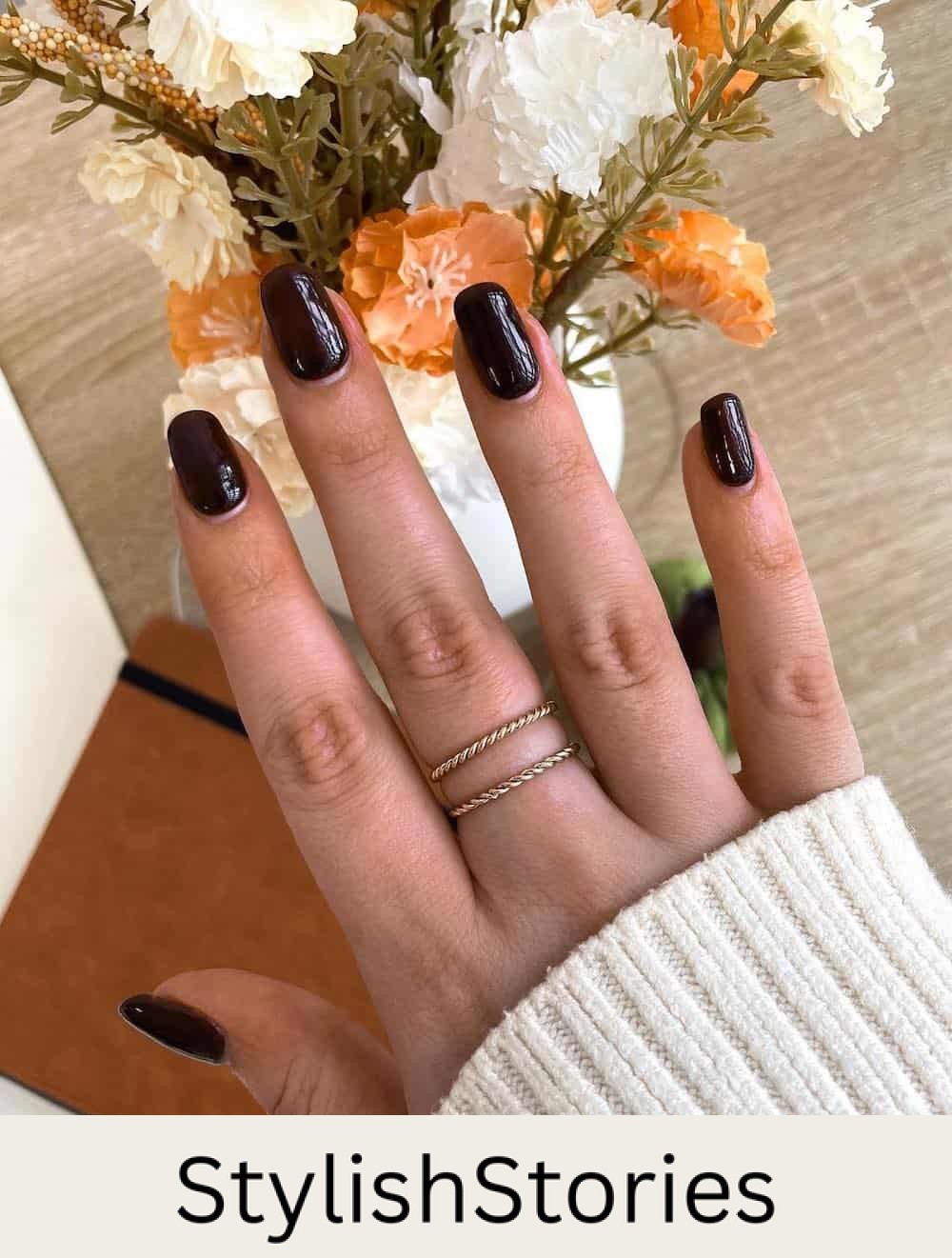 short squoval nails with dark brown polish