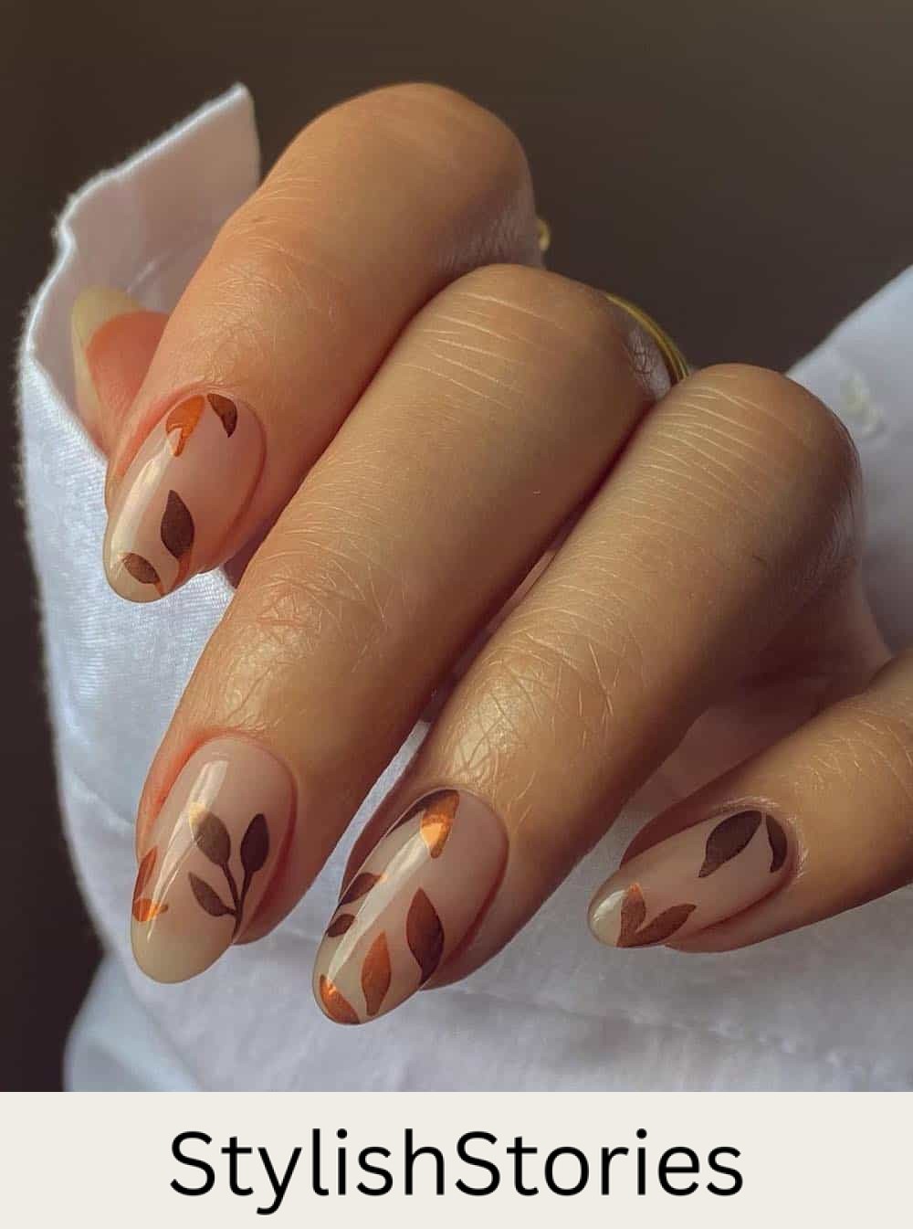 short nude almond nails with brown and copper leaf art