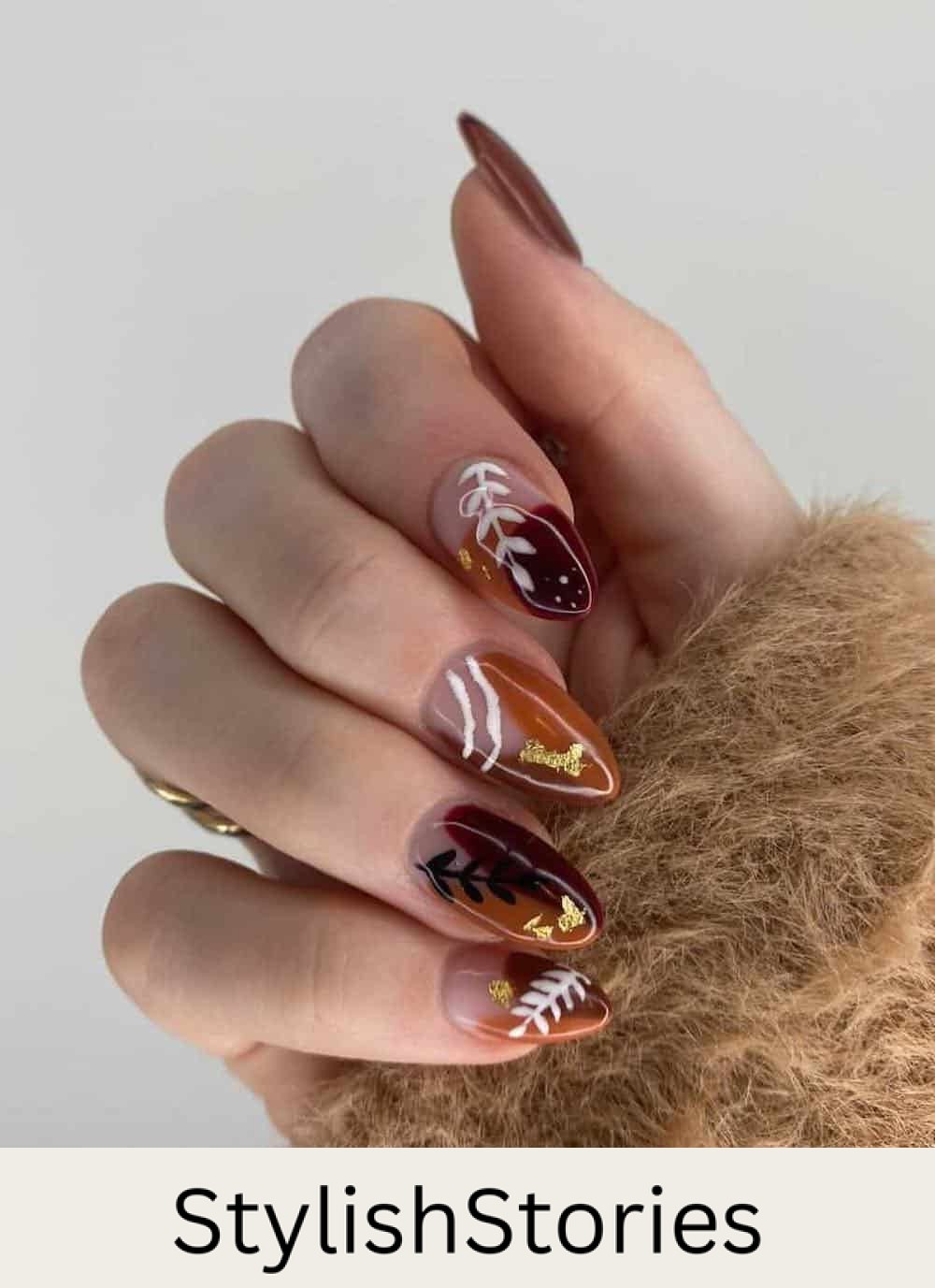 brown and camel nails with boho style art and gold foil