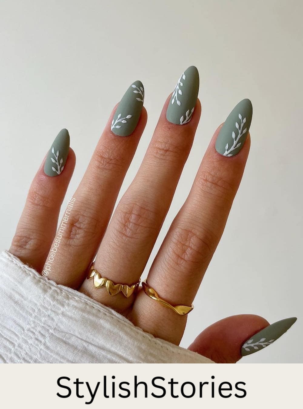 medium matte green almond nails with white leaf art