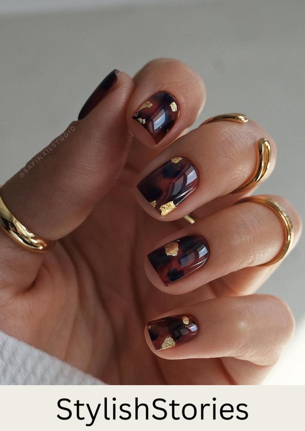 short glossy nails with brown and black tortoise shell print and gold foil