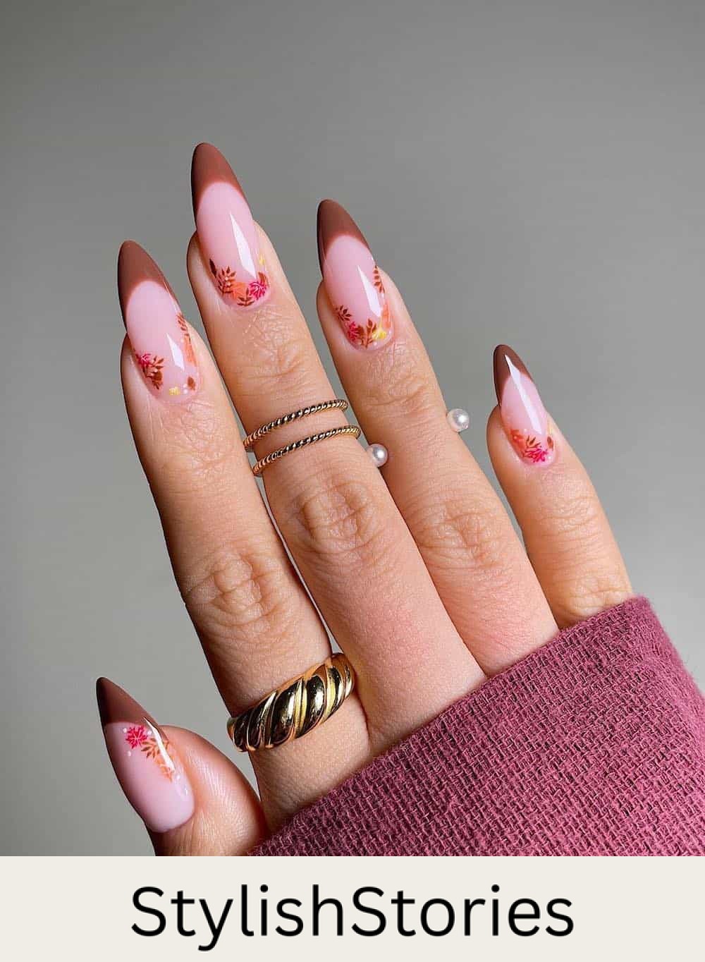 long nude almond nails with brown tips and autumn botanical nail art