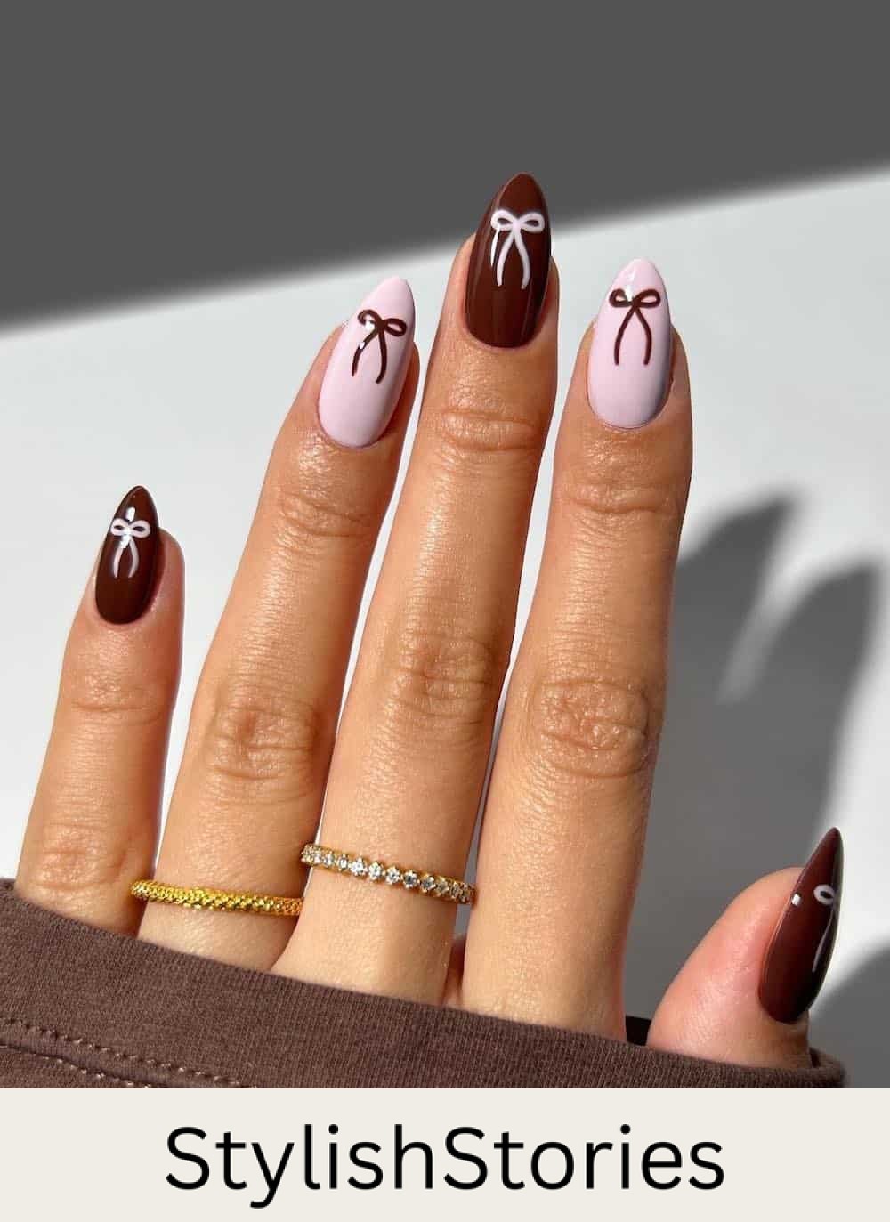 medium burgundy and light pink almond nails with bow details