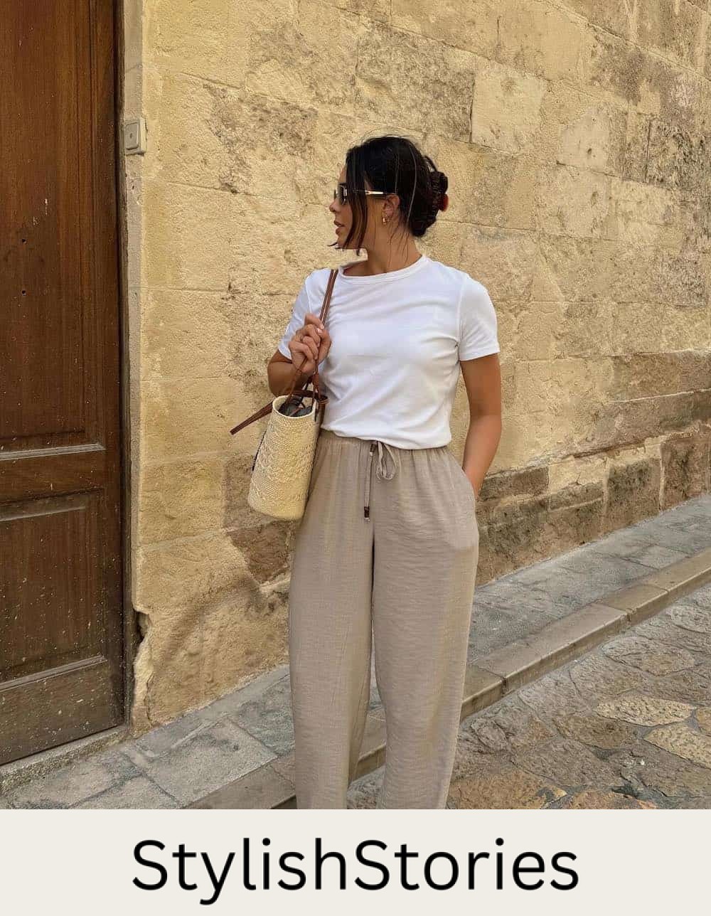 Woman wearing draw string linen pants with a white baby tee.