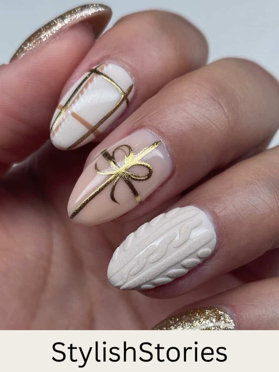 short almond nails featuring white, gold, and cream colored polish with sweater nail art, plaid, and ribbon and bow accents
