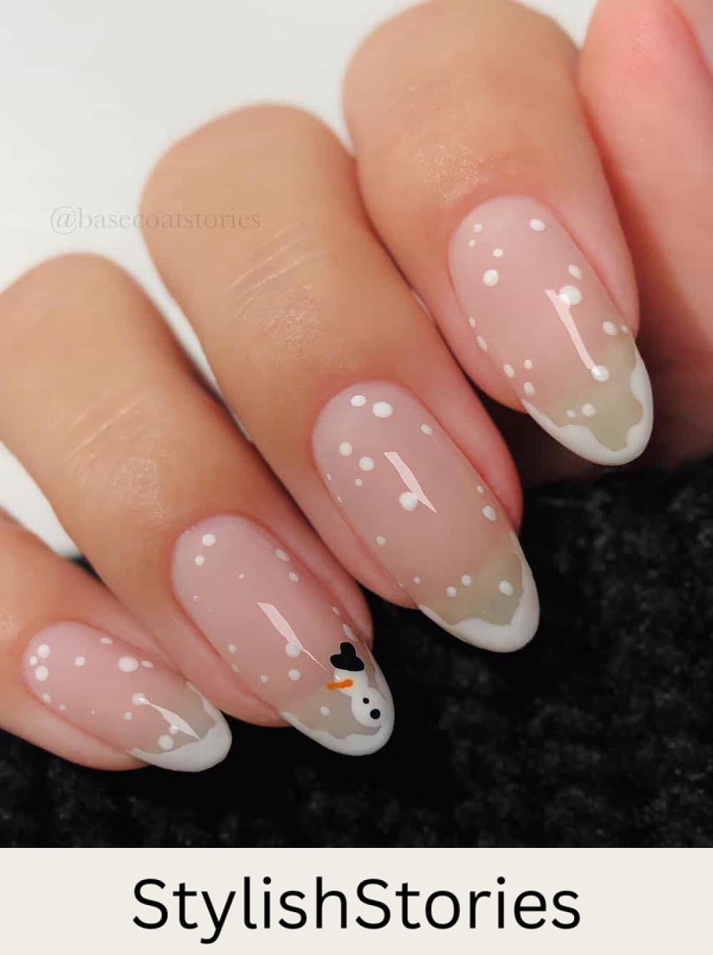 long glossy round nails with snowy french tips and a snowman accent