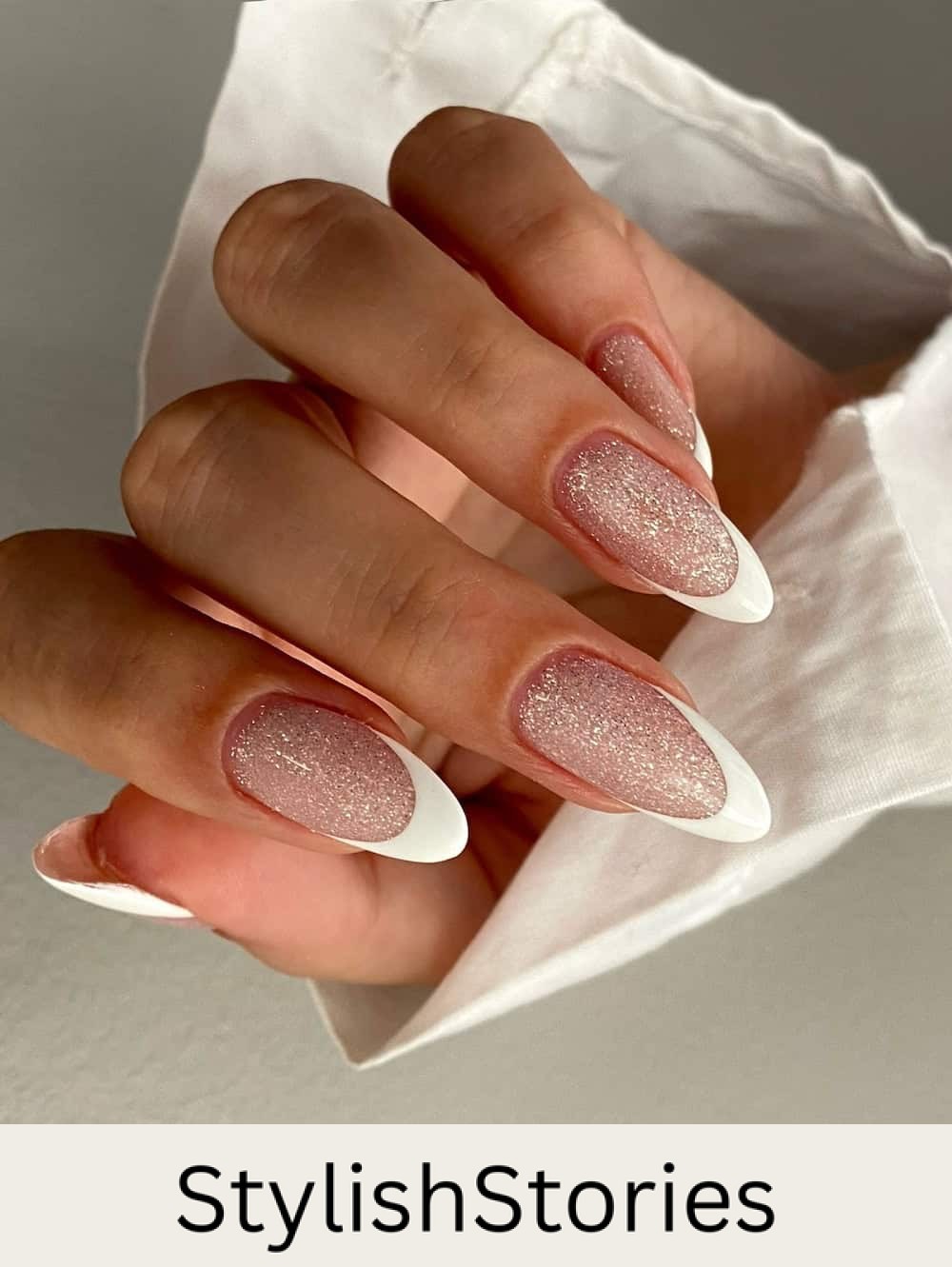 long almond nails with a glitter basecoat and white tips