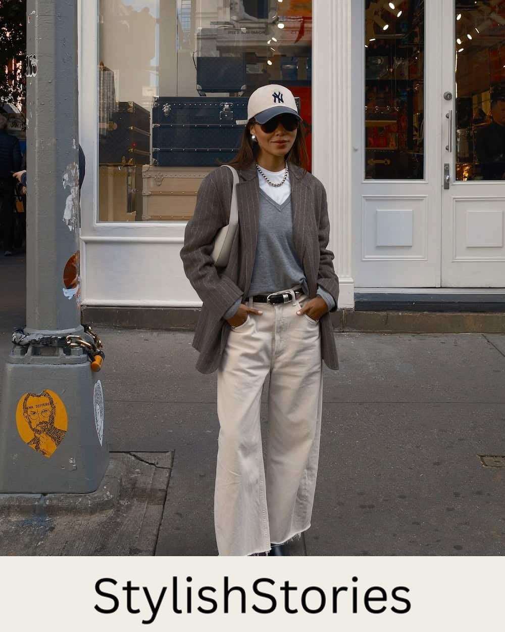 Woman wearing tan wide leg jeans and an oversized blazer.