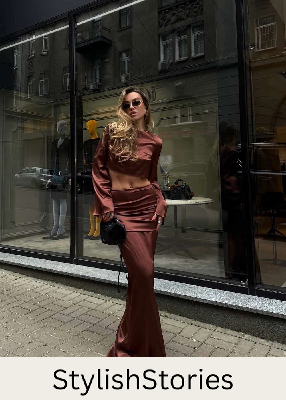 Woman wearing a burgundy satin long skirt set.