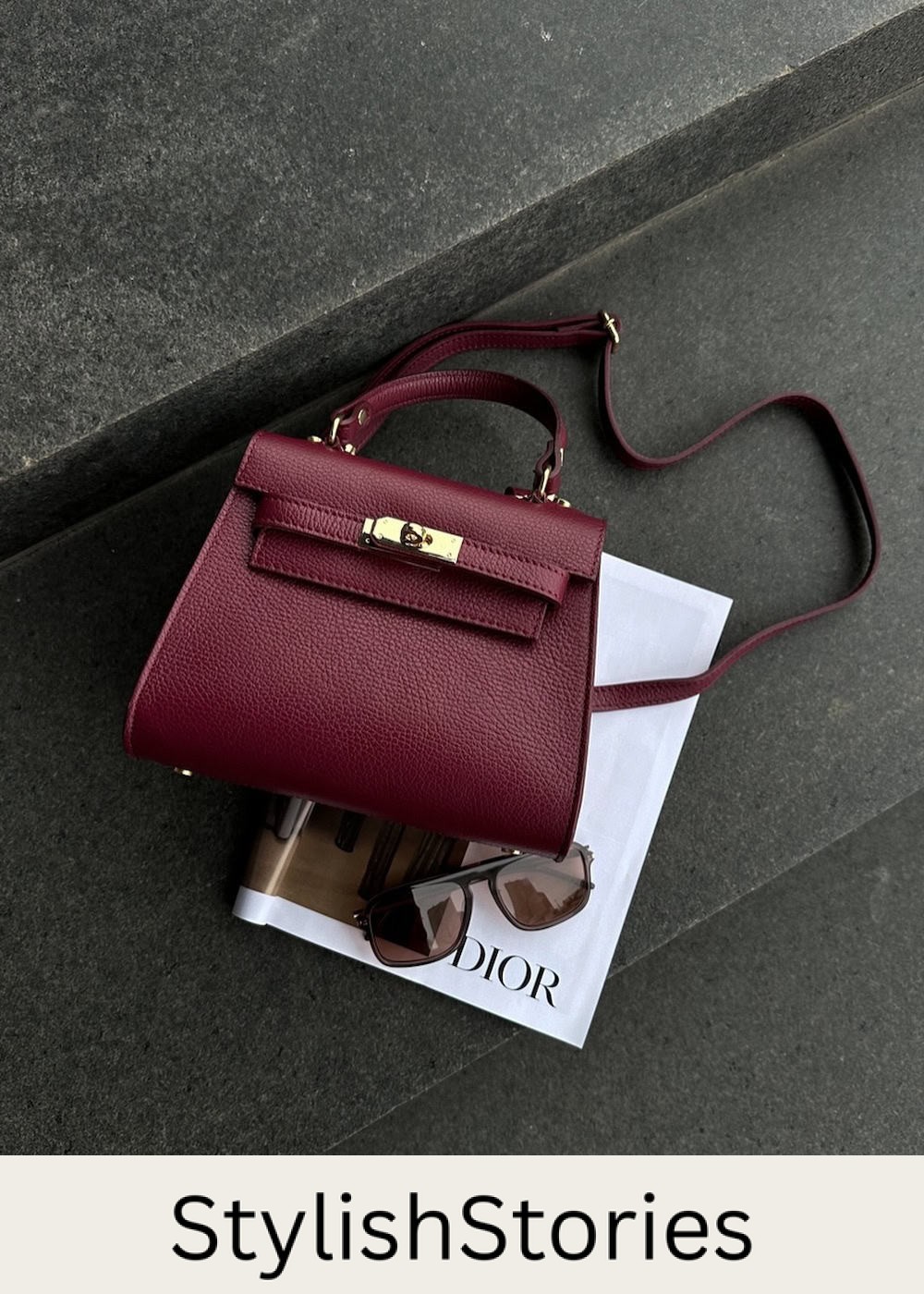 A burgundy Hermes bag on top of a Dior magazine